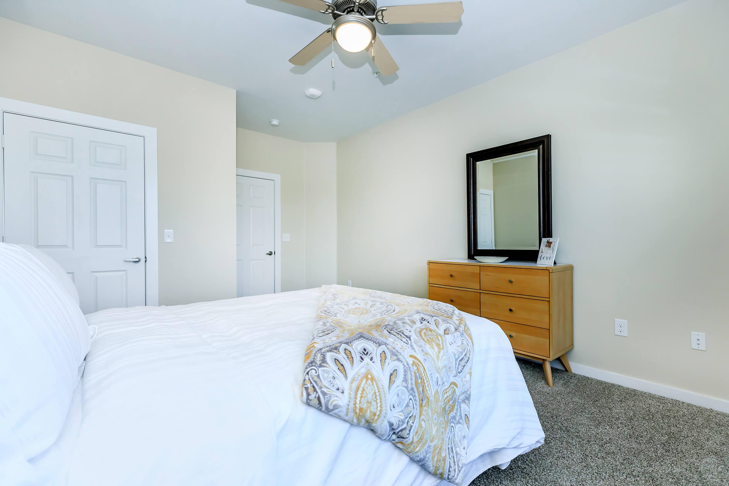 a bedroom with a bed and desk in a small room