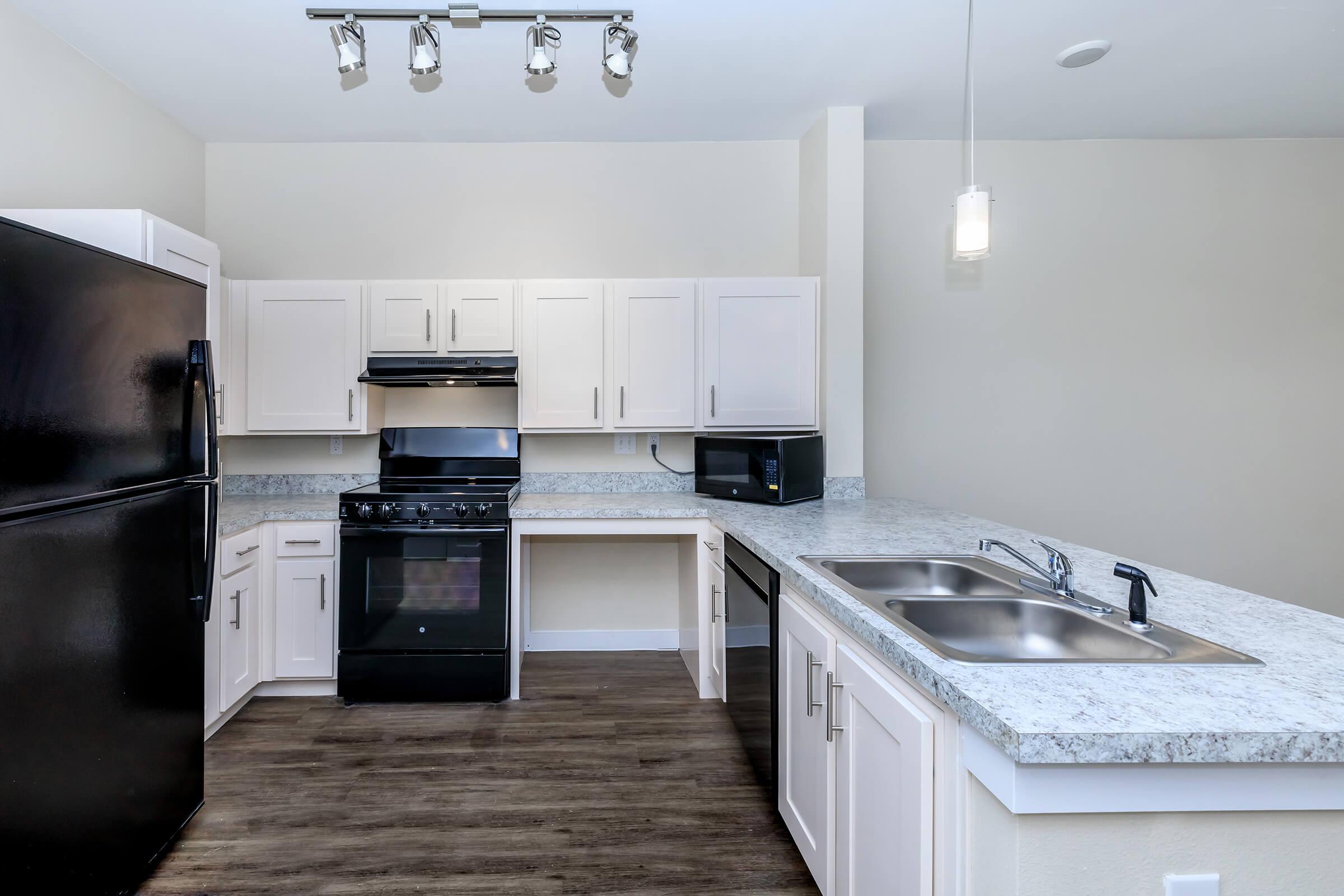 Apartments for Rent in Leander TX - Hills at Leander Spacious Kitchen with Plenty of Counterspace, Fully Equipped with Black Appliances, and Much More