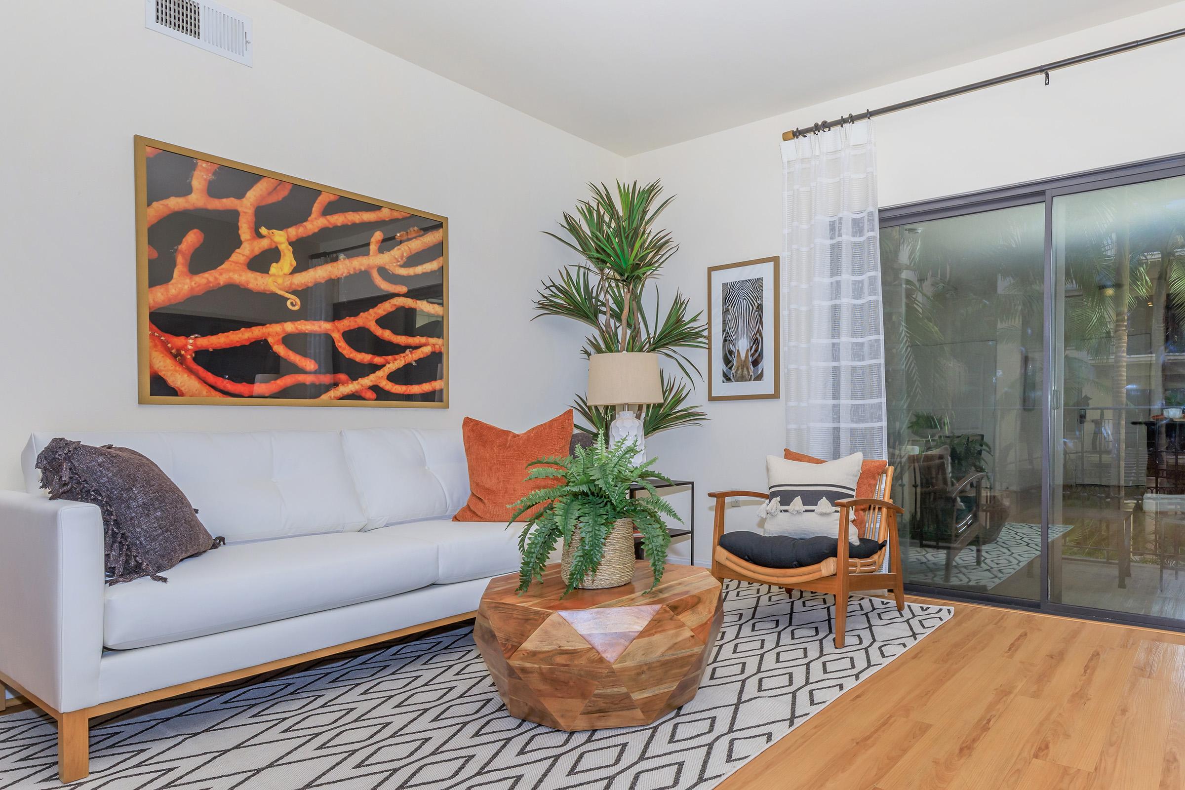 a living room filled with furniture and a flat screen tv