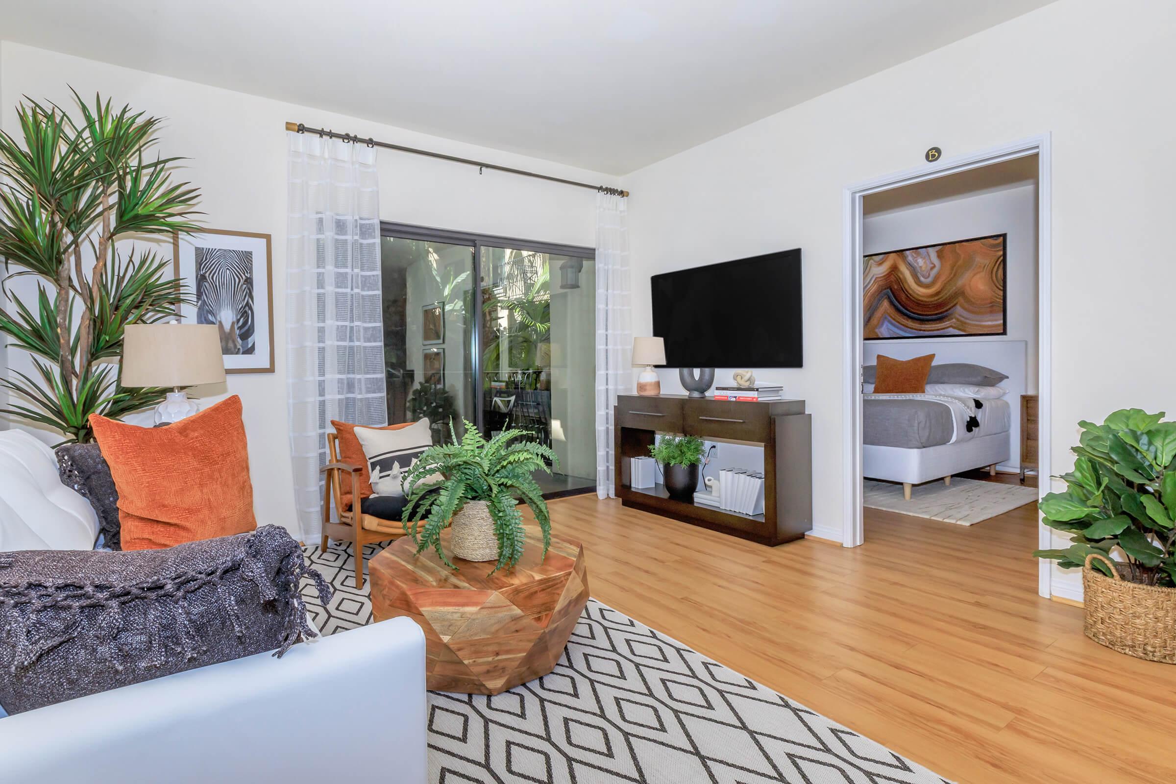 a living room filled with furniture and a flat screen tv