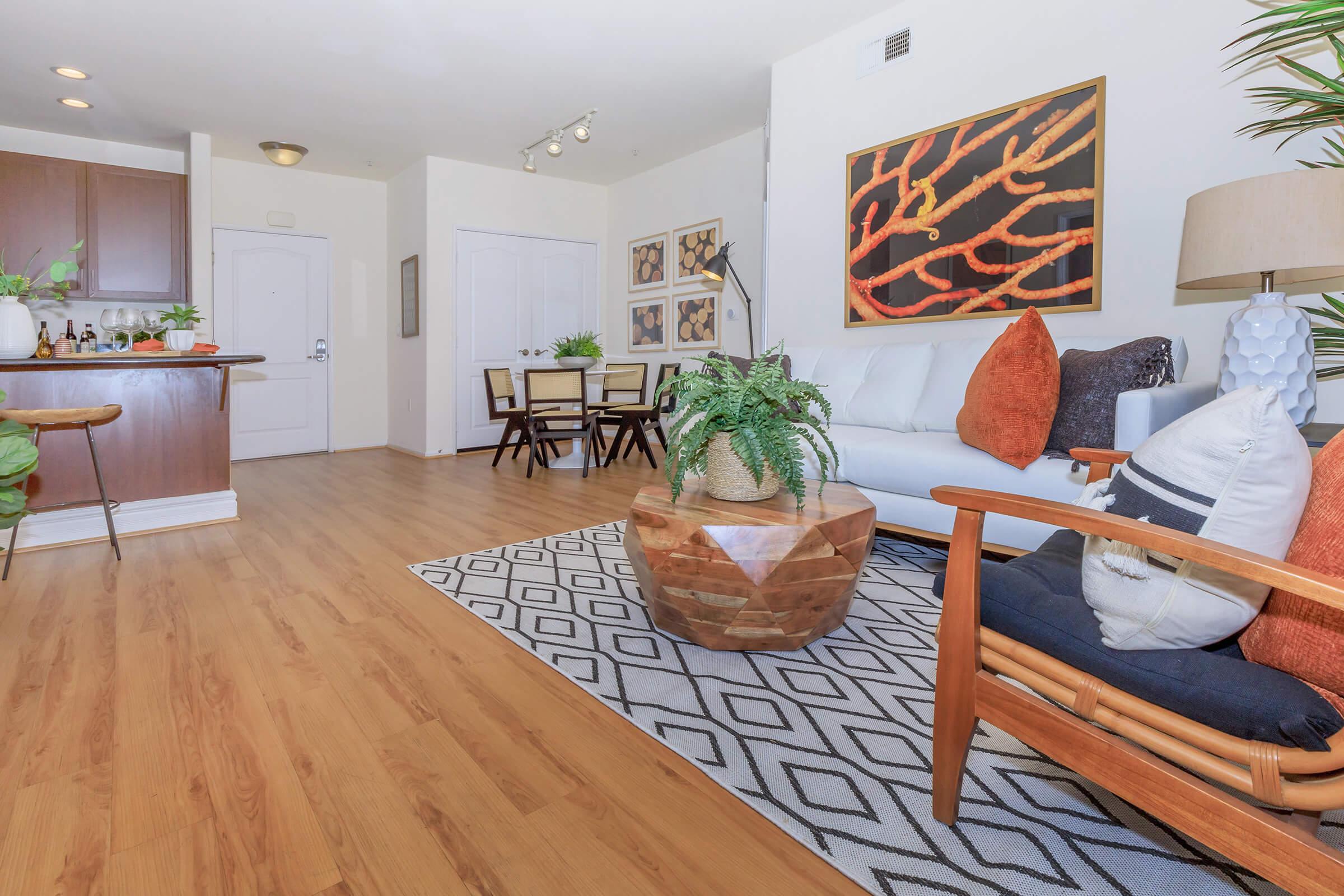 a living room filled with furniture on top of a wooden table