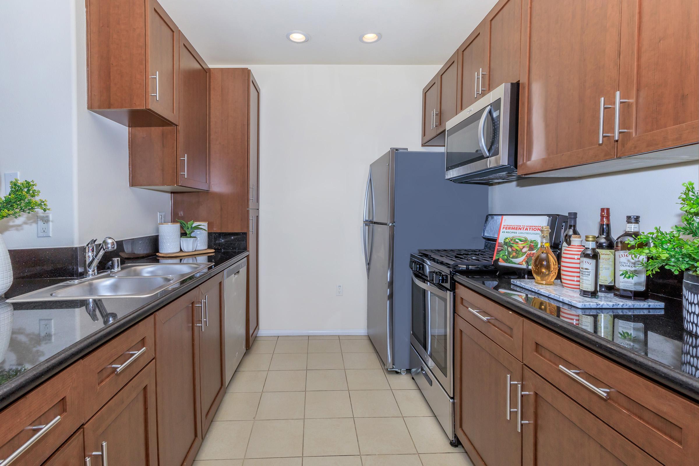 a kitchen with stainless steel appliances and wooden cabinets