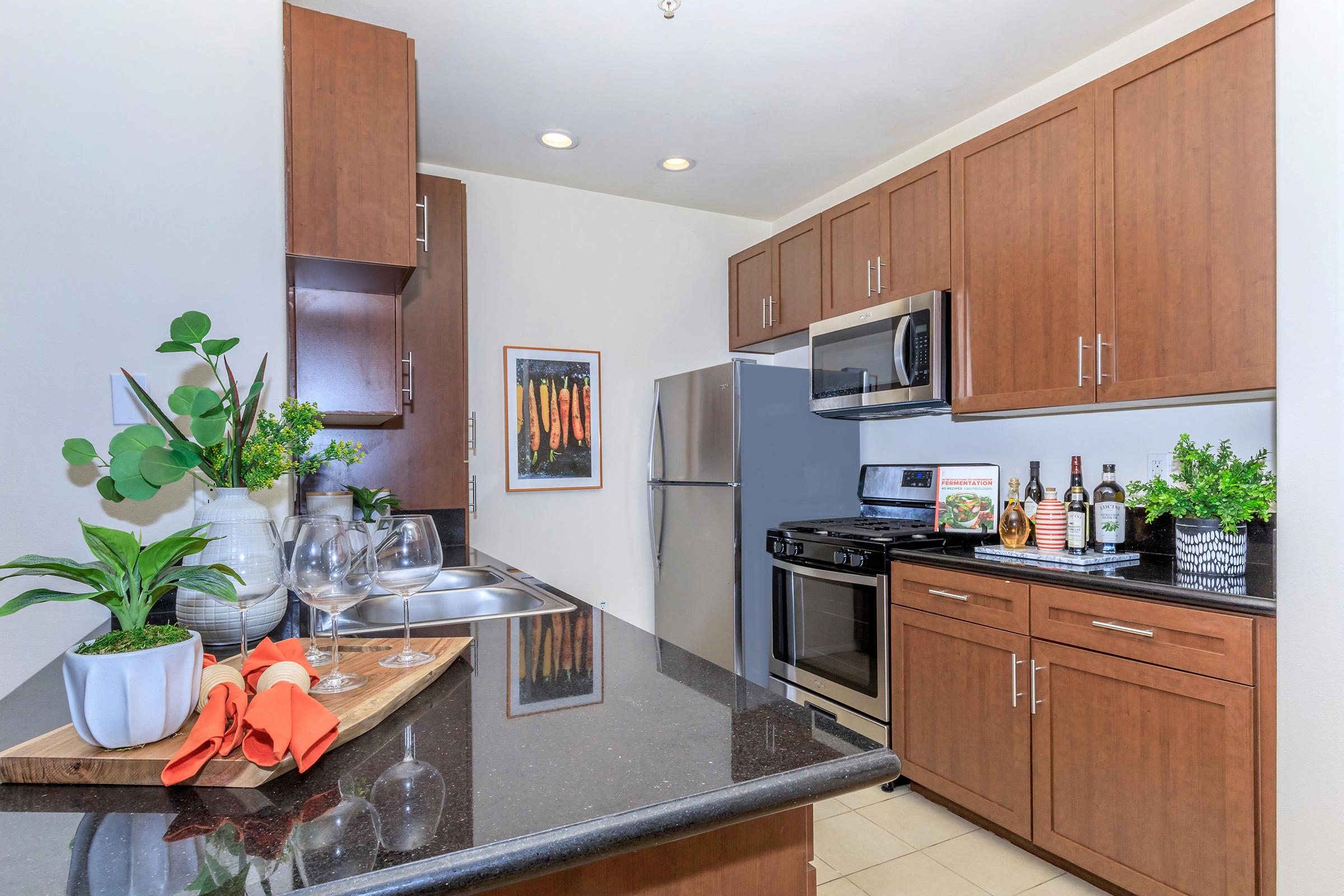 a kitchen with stainless steel appliances and wooden cabinets