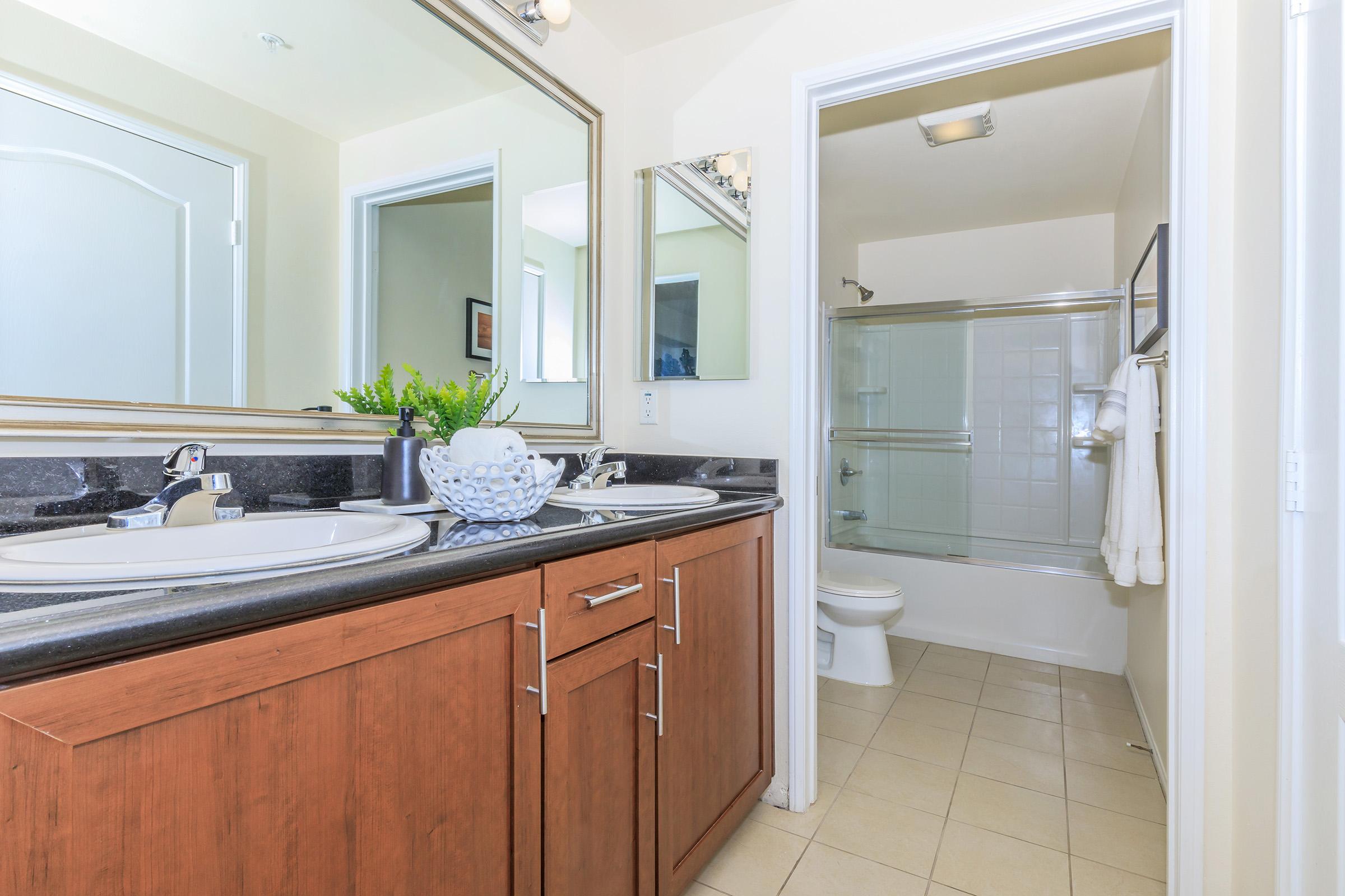 a kitchen with a sink and a mirror