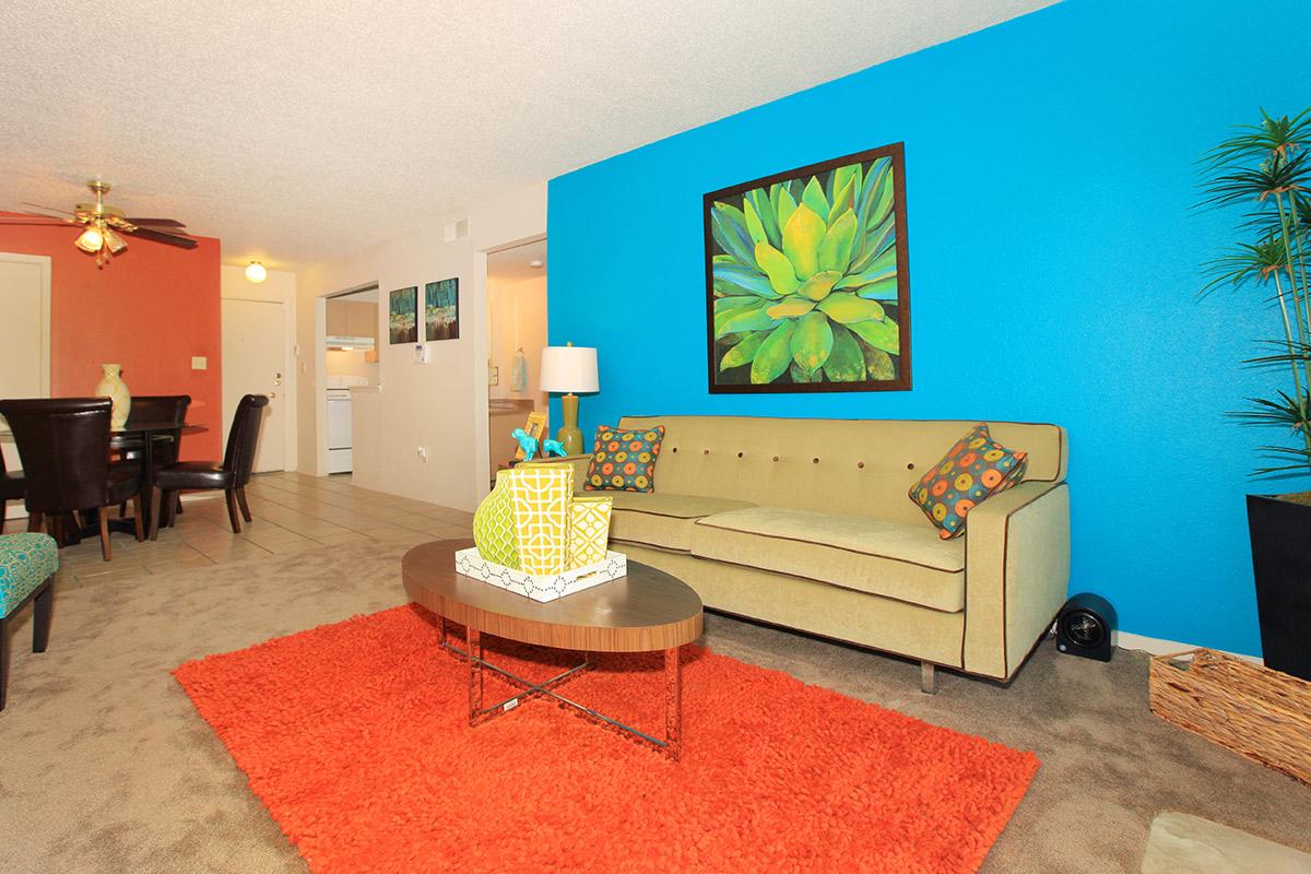 a living room filled with furniture and a flat screen tv