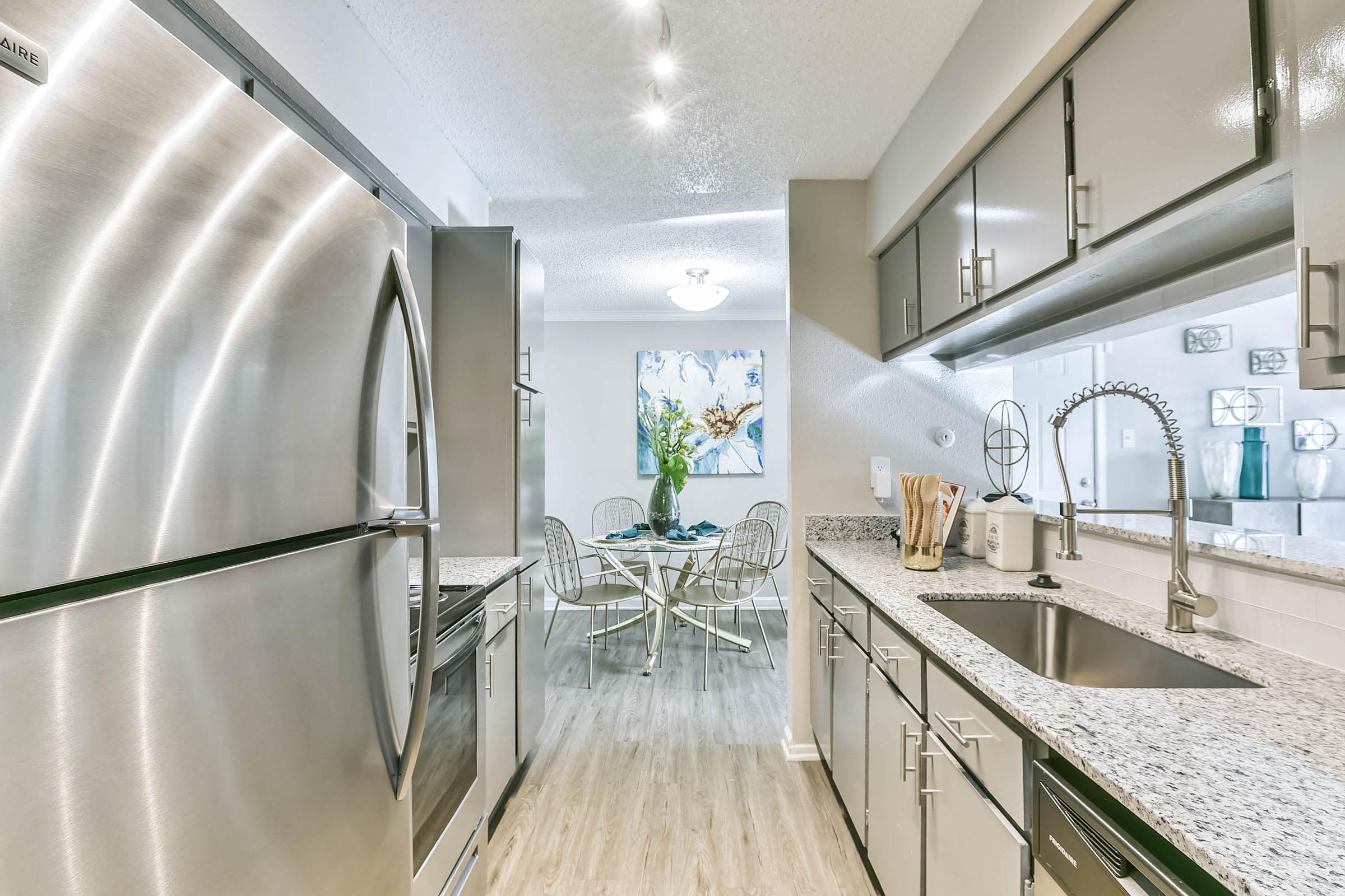 a kitchen with a sink and a mirror