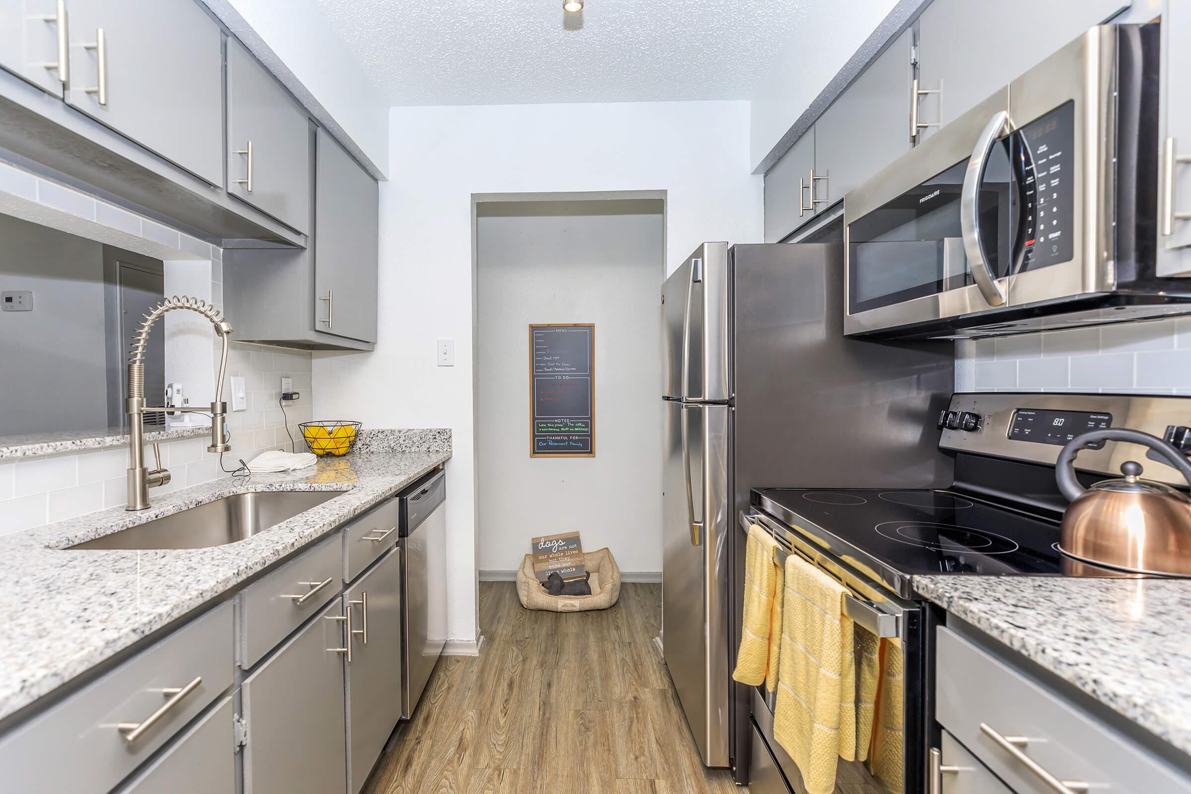 a large kitchen with stainless steel appliances