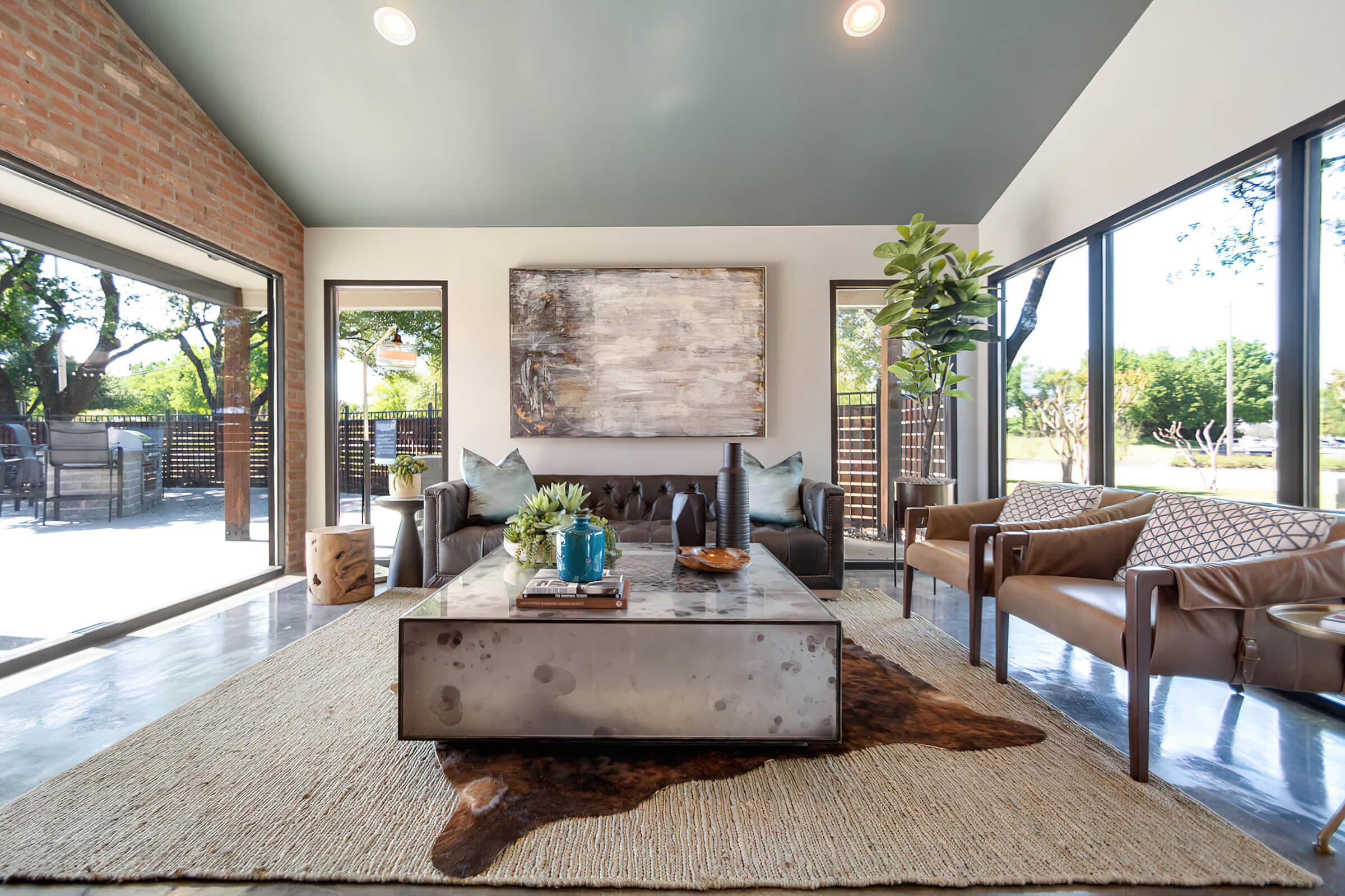 a living room filled with furniture and a large window