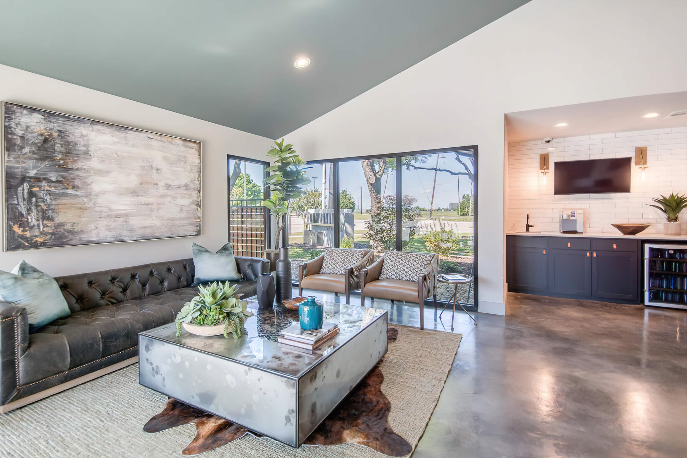 a living room filled with furniture and a large window