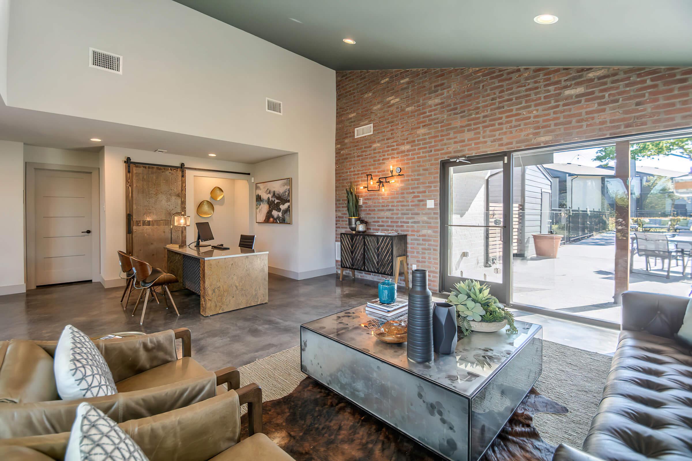 a living room filled with furniture and a large window