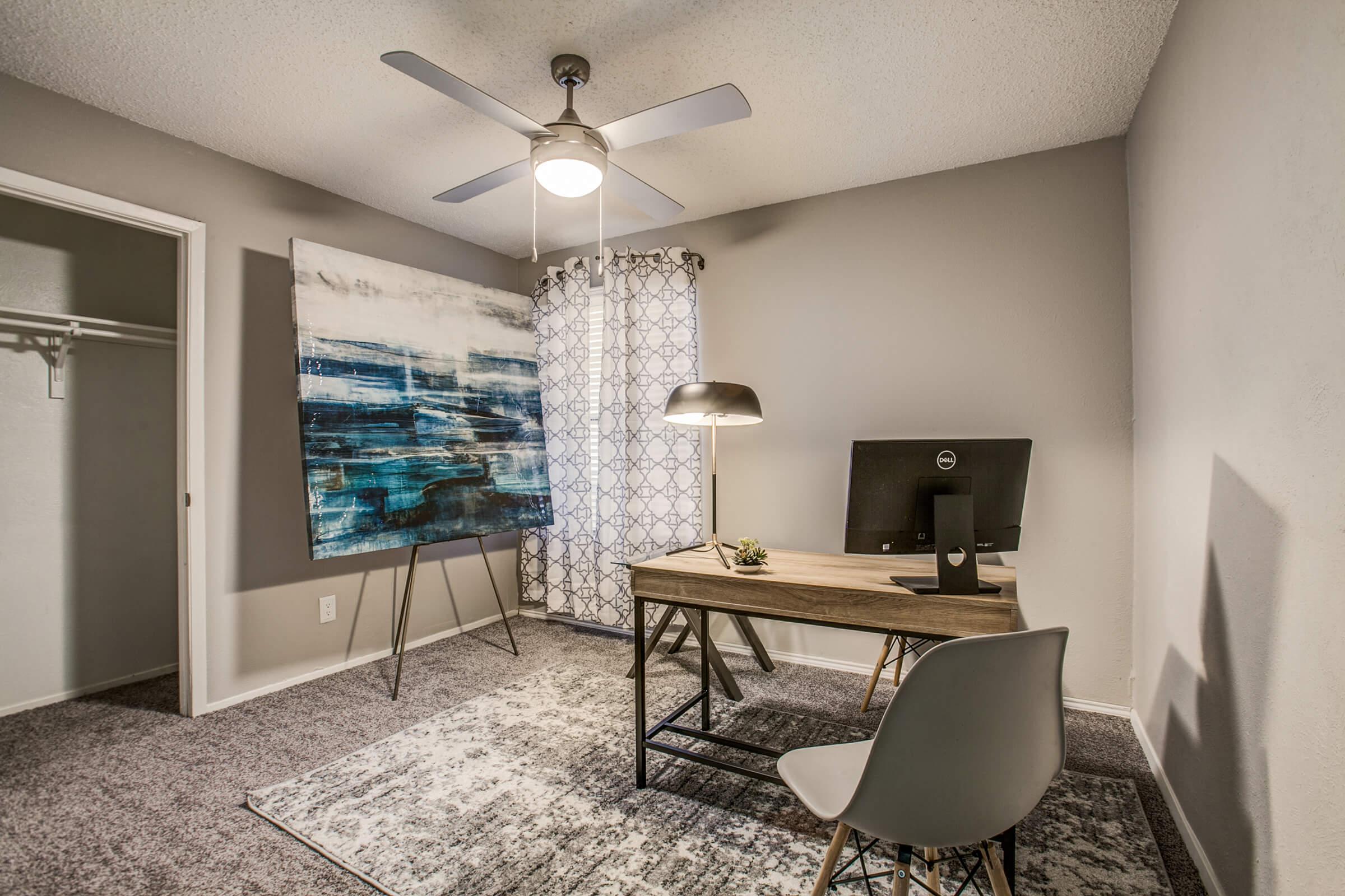 a bedroom with a bed and a chair in a room