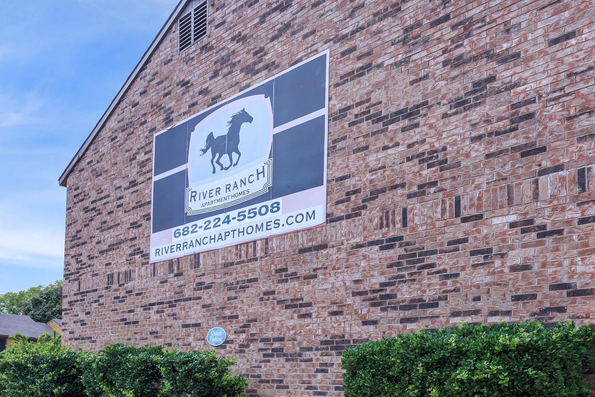 a sign in front of a brick building