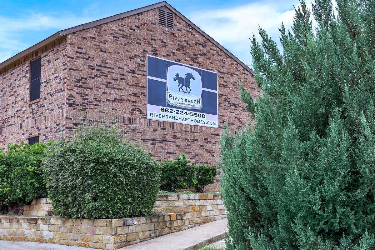 a sign in front of a brick building