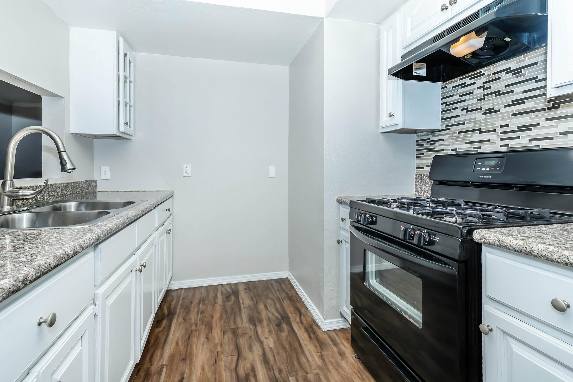 a kitchen with a stove top oven