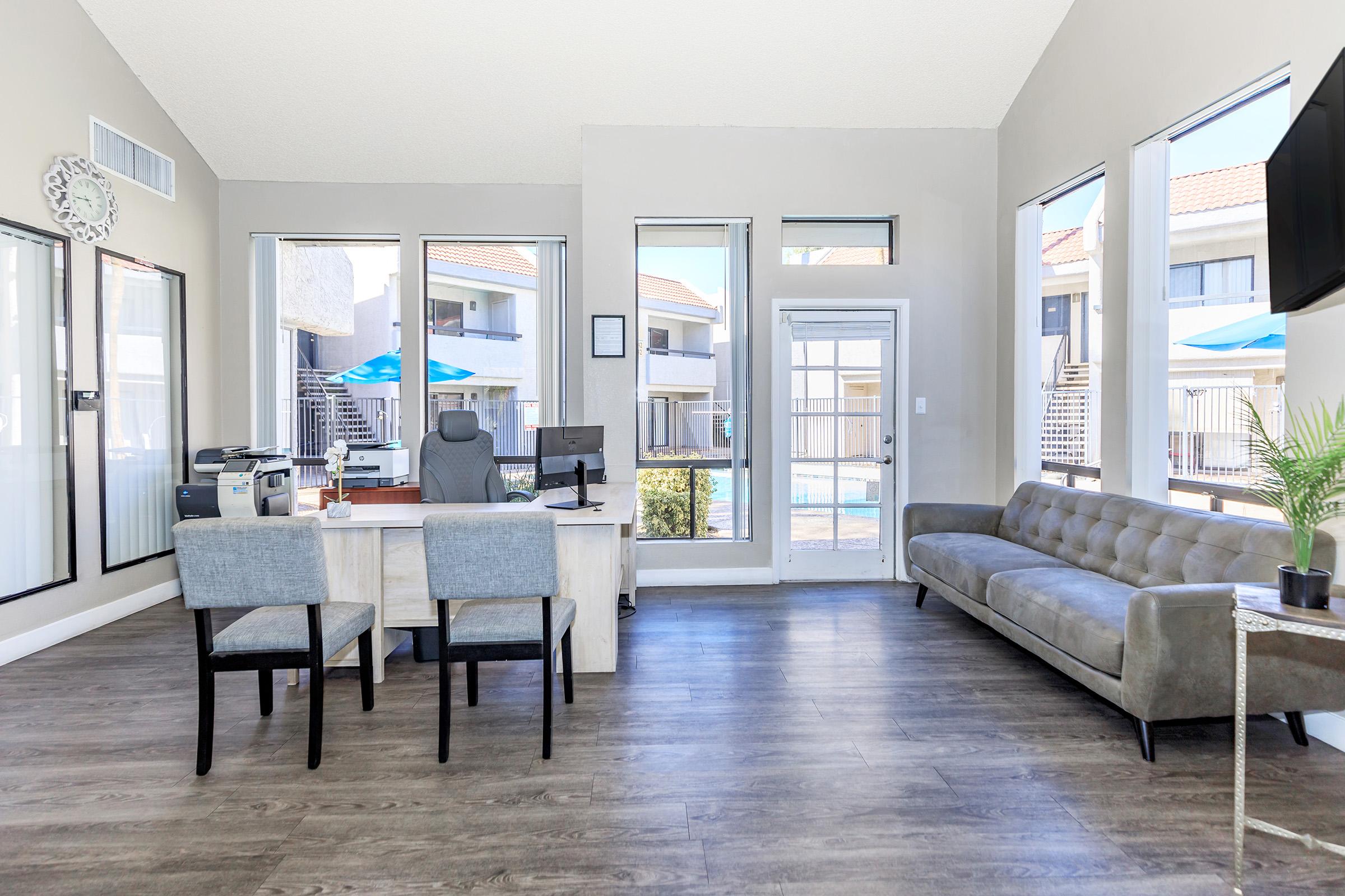 a living room filled with furniture and a large window