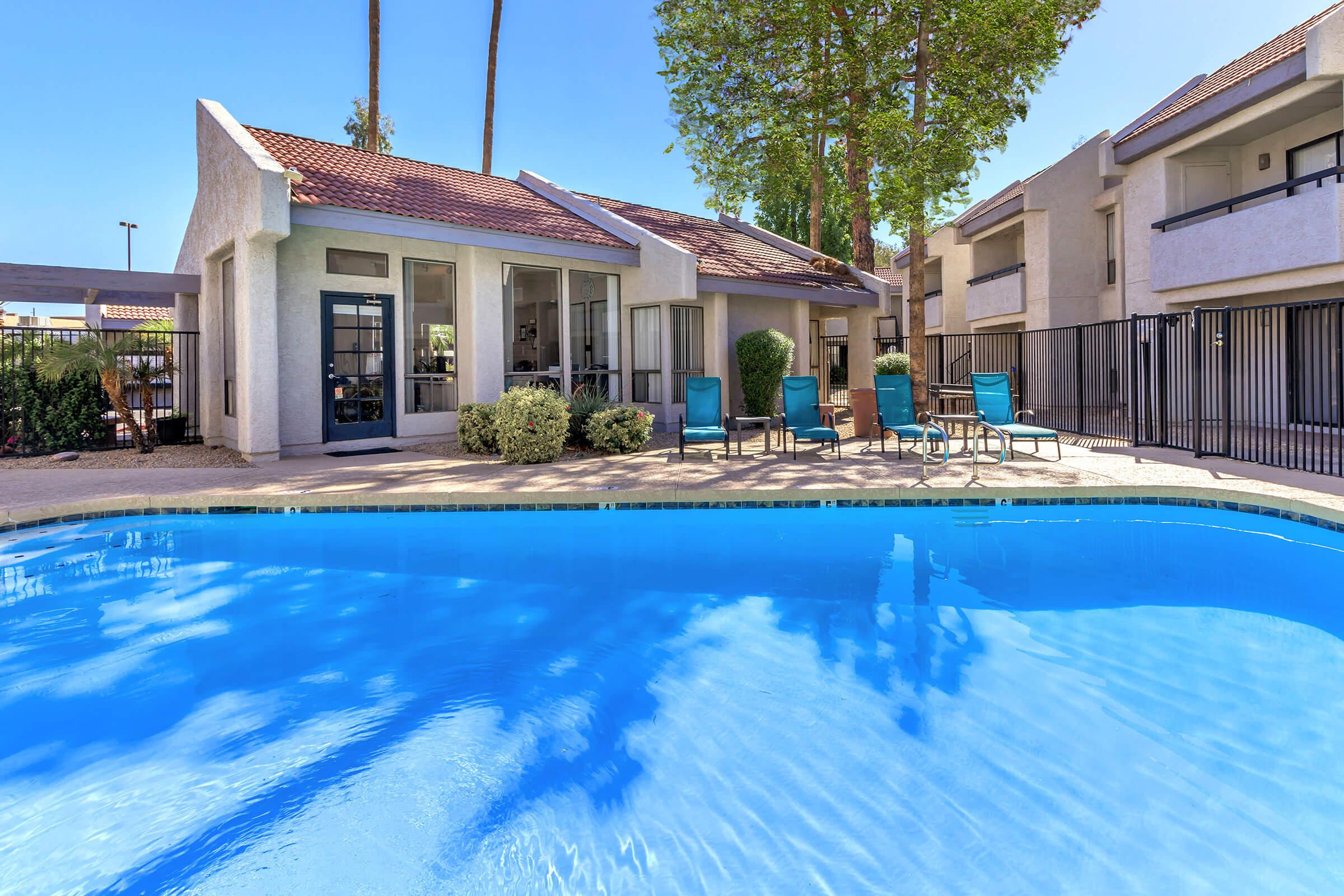 a blue pool of water in front of a building