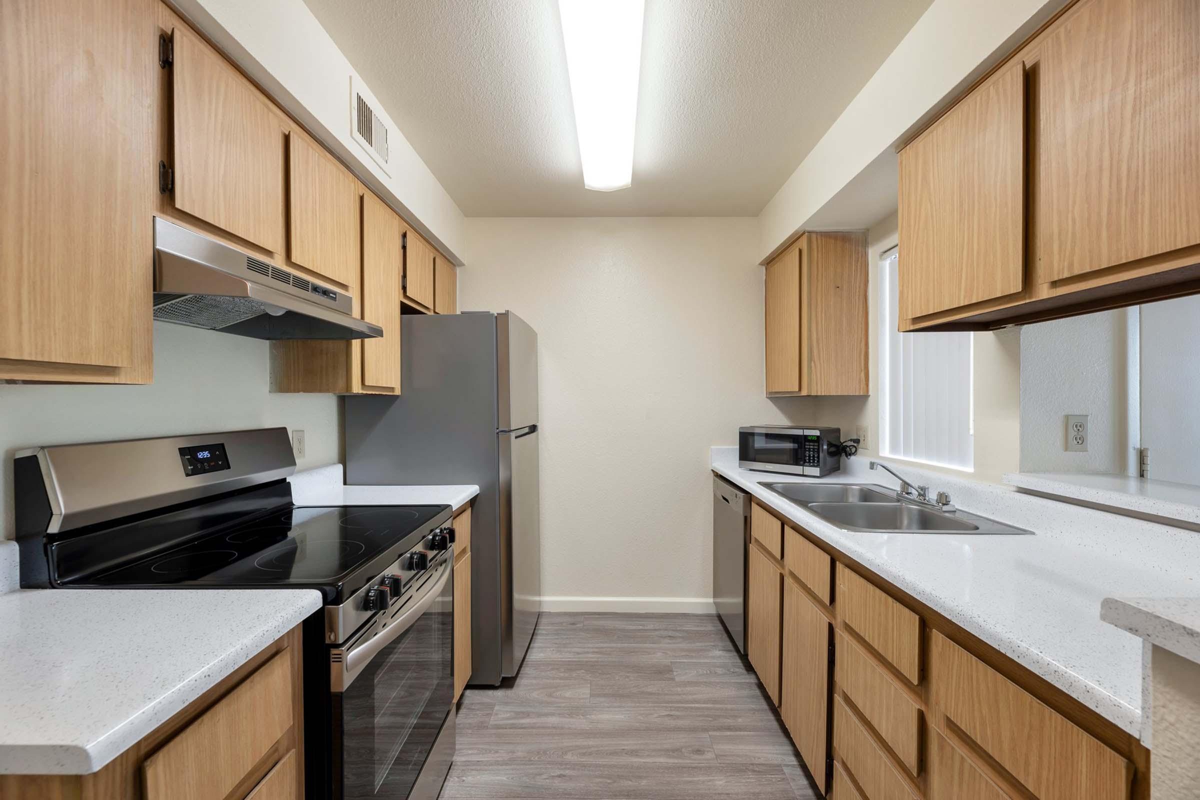 a kitchen with stainless steel appliances and wooden cabinets