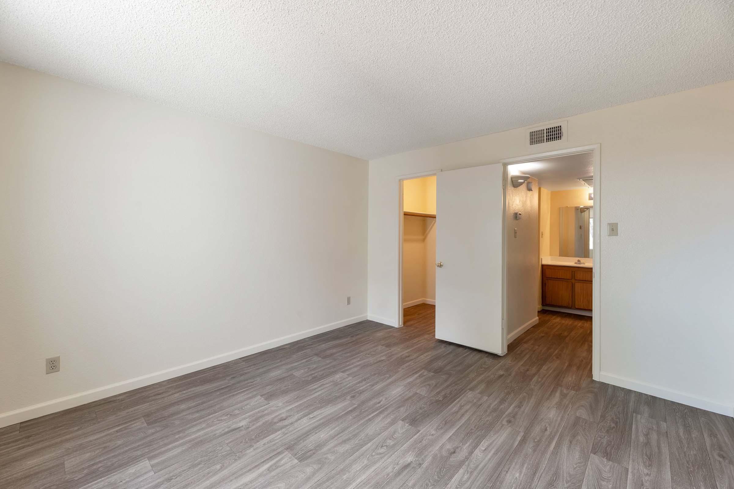 a large empty room with a wood floor