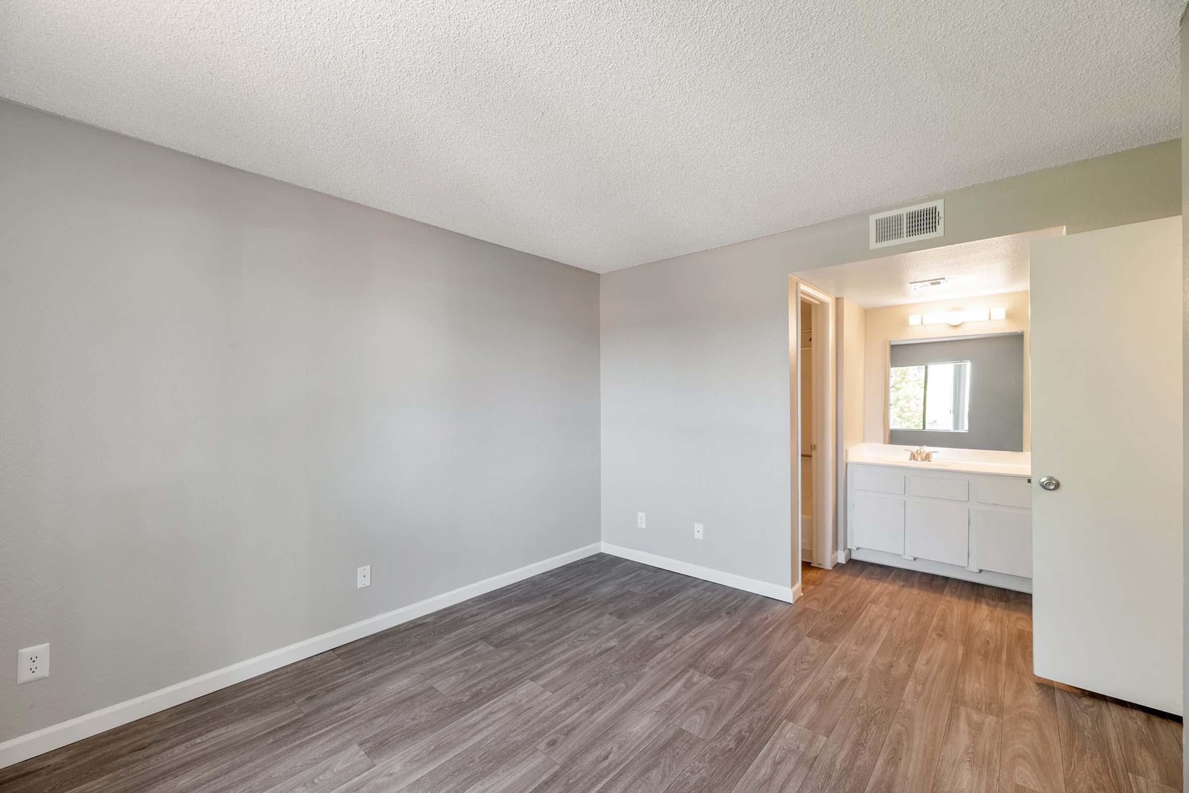 a large empty room with a wood floor