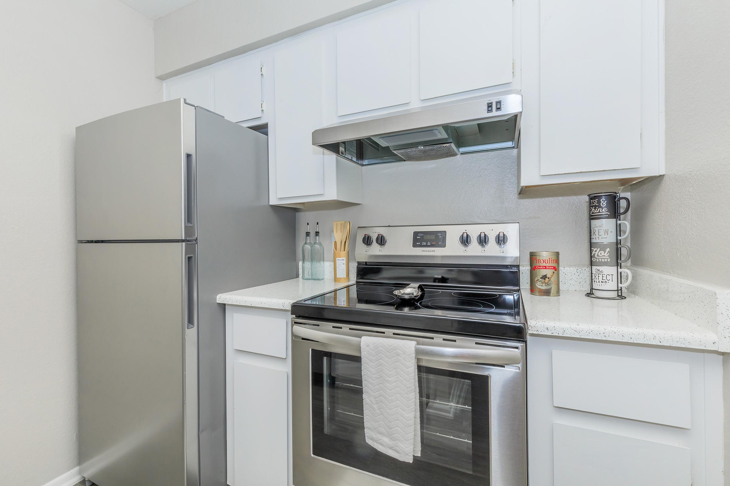 a kitchen with a stove top oven sitting inside of a refrigerator