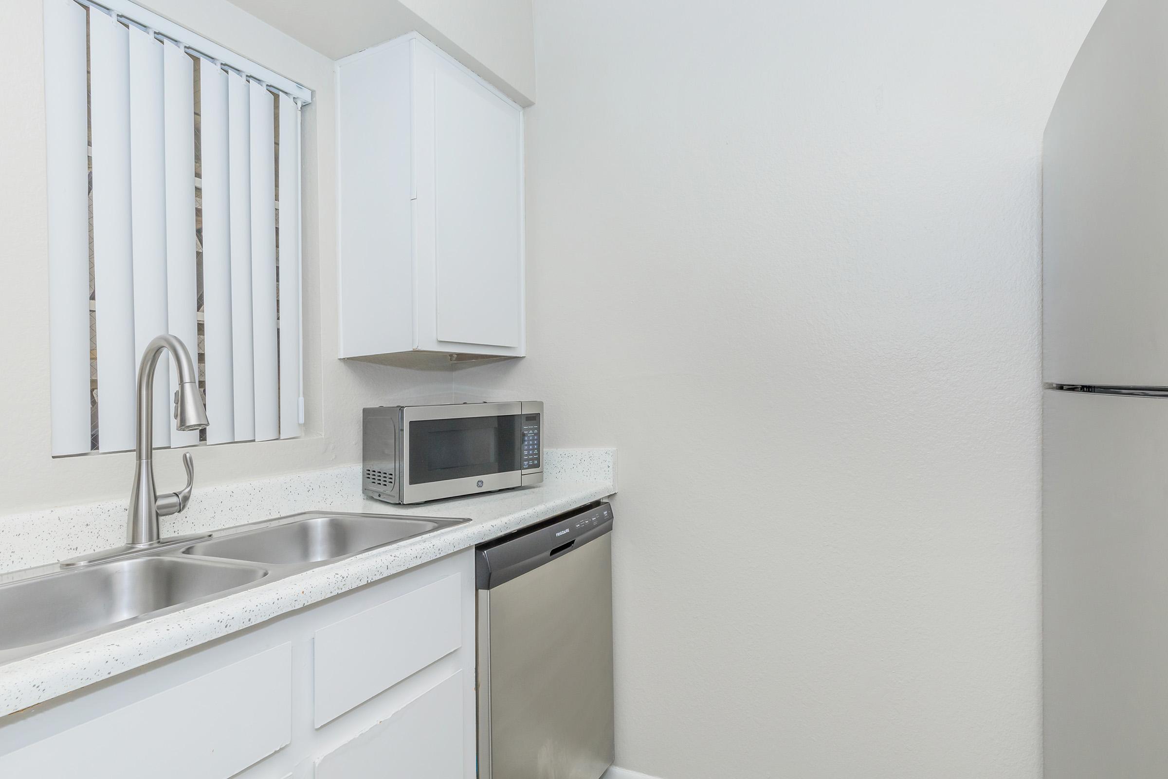 a kitchen with a sink and a refrigerator