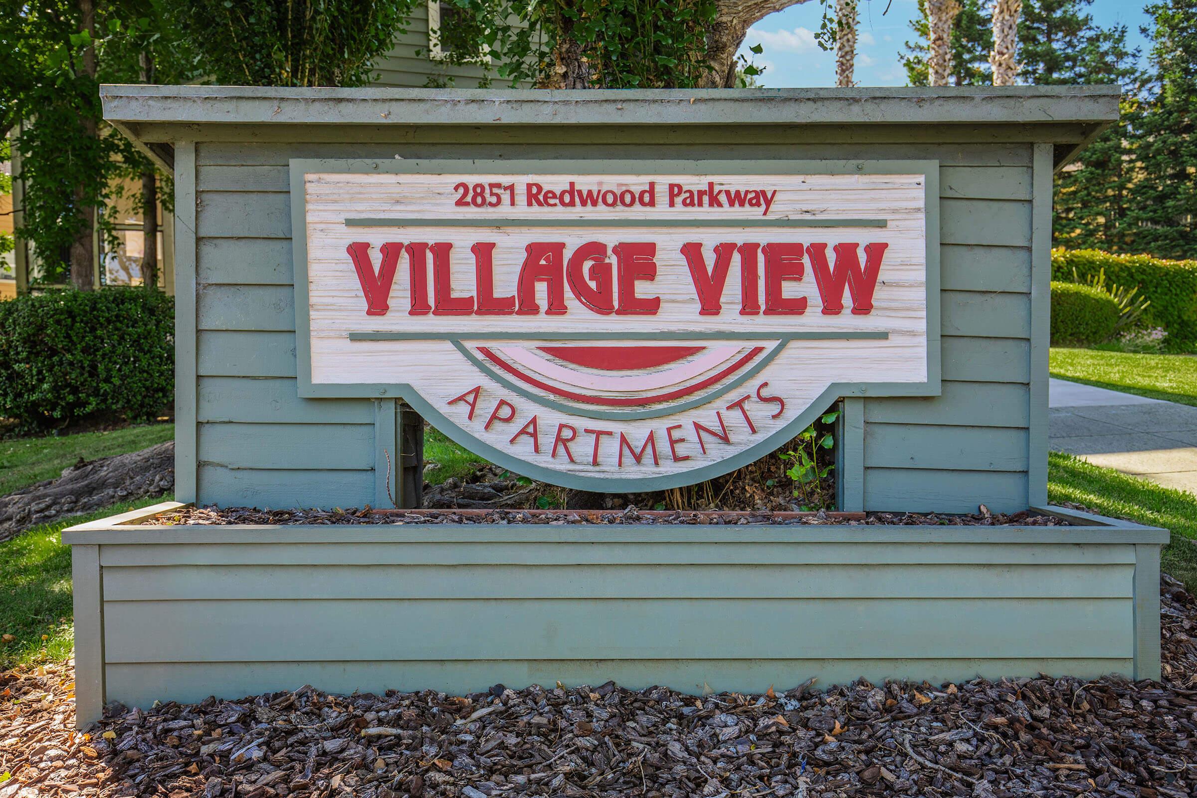 a sign on a bench in front of a house