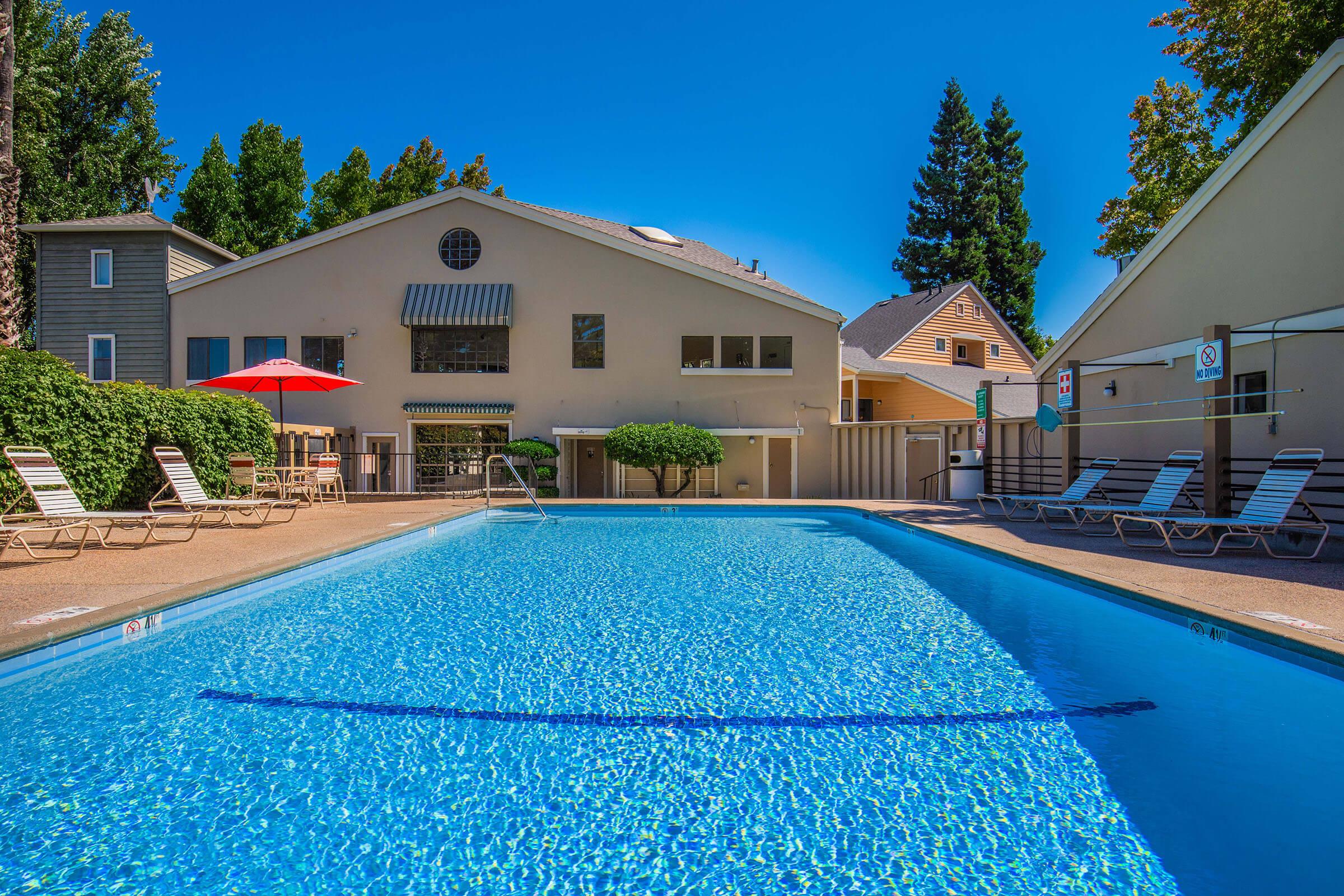 a house with a pool in front of a building