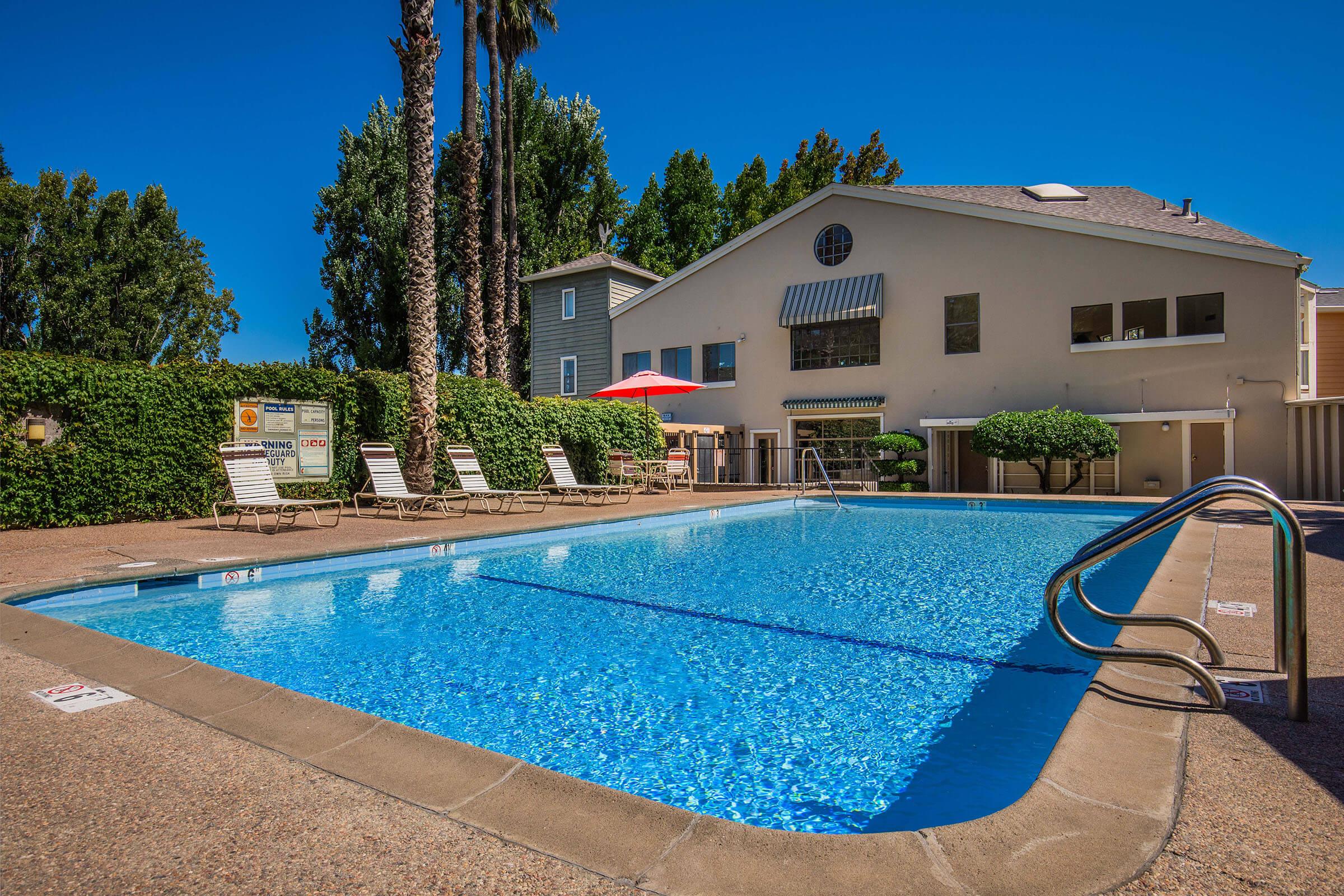 a house with a pool in front of a building