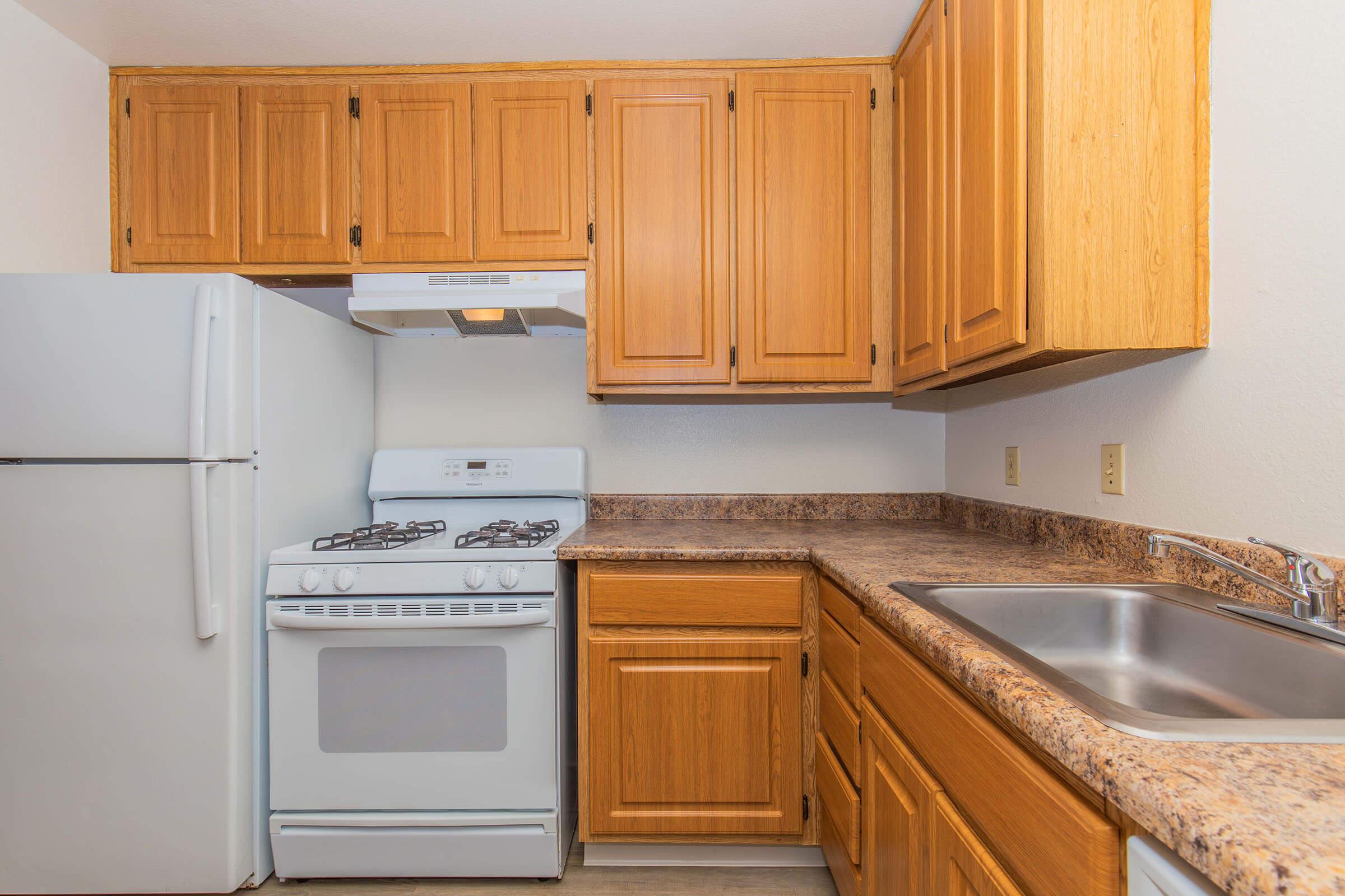 a kitchen with wooden cabinets and a microwave