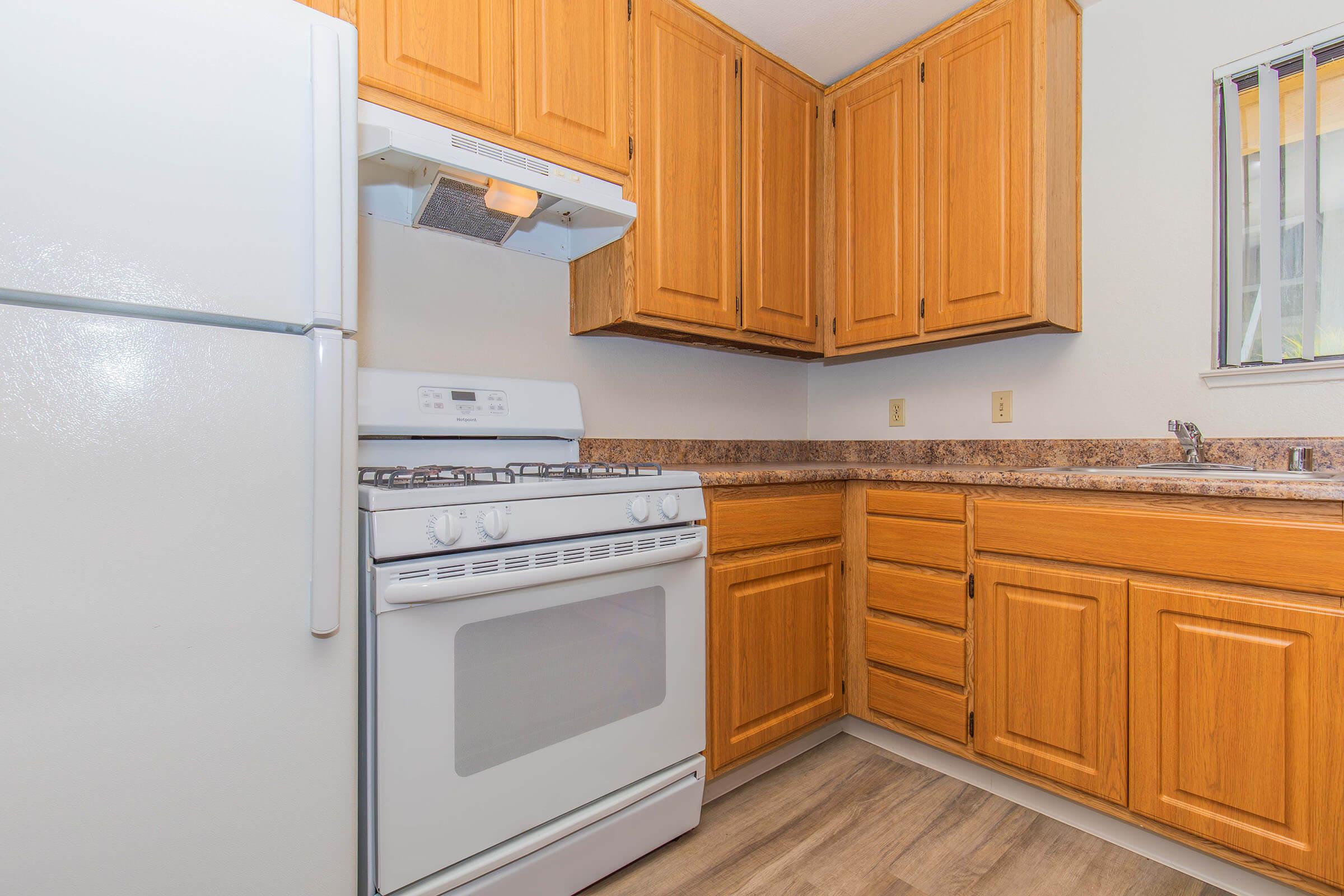 a kitchen with a stove top oven sitting inside of a refrigerator