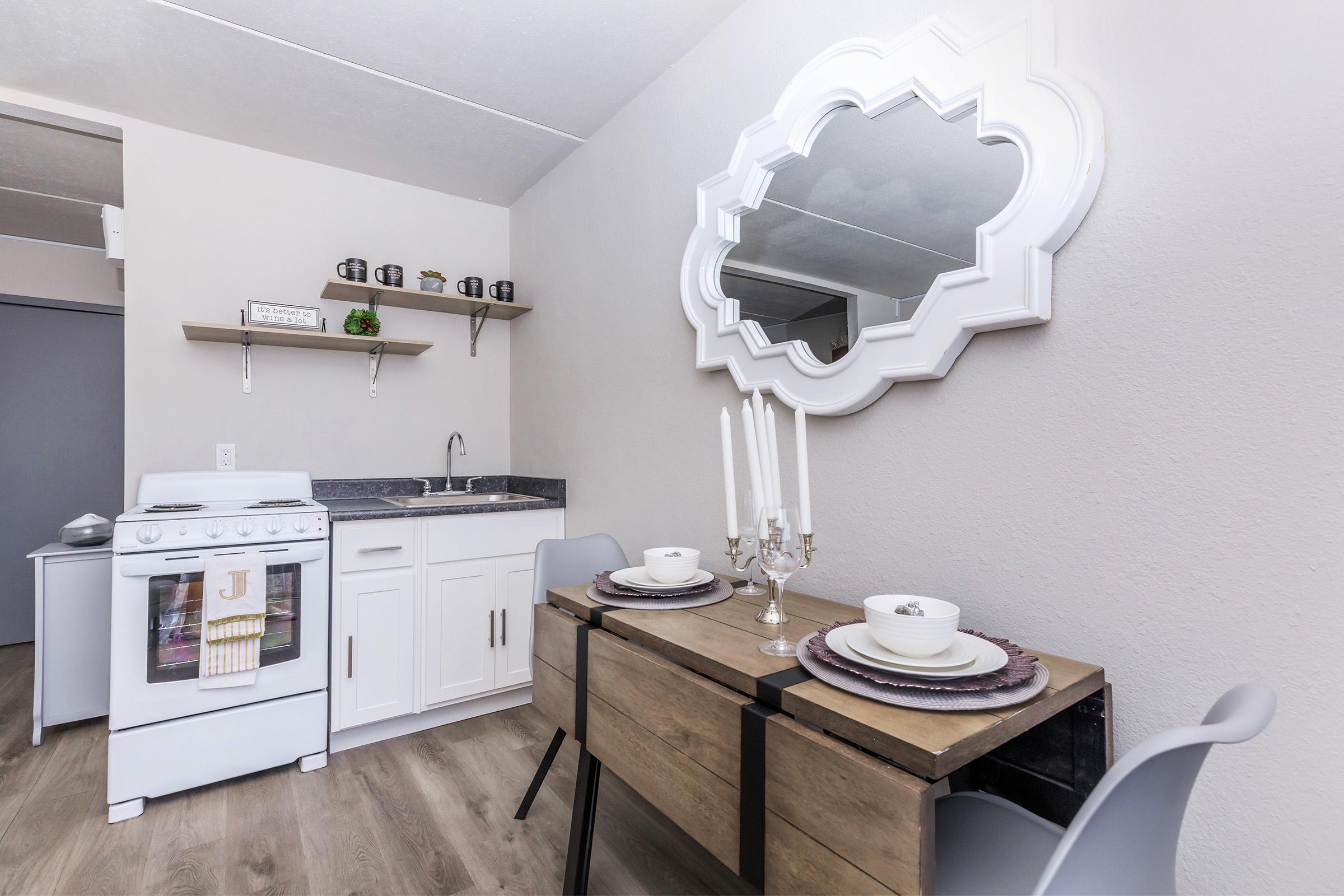 a kitchen with a sink and a mirror