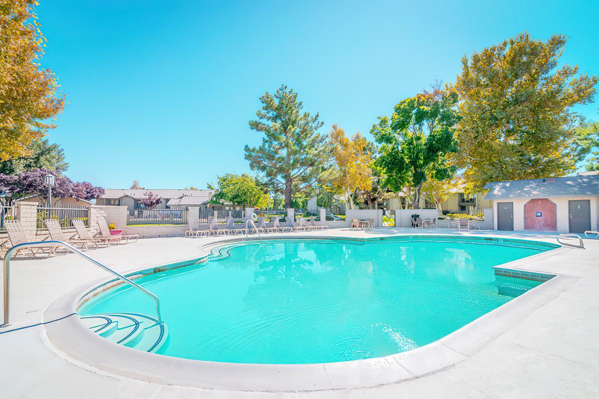 a man riding a skateboard up the side of a swimming pool