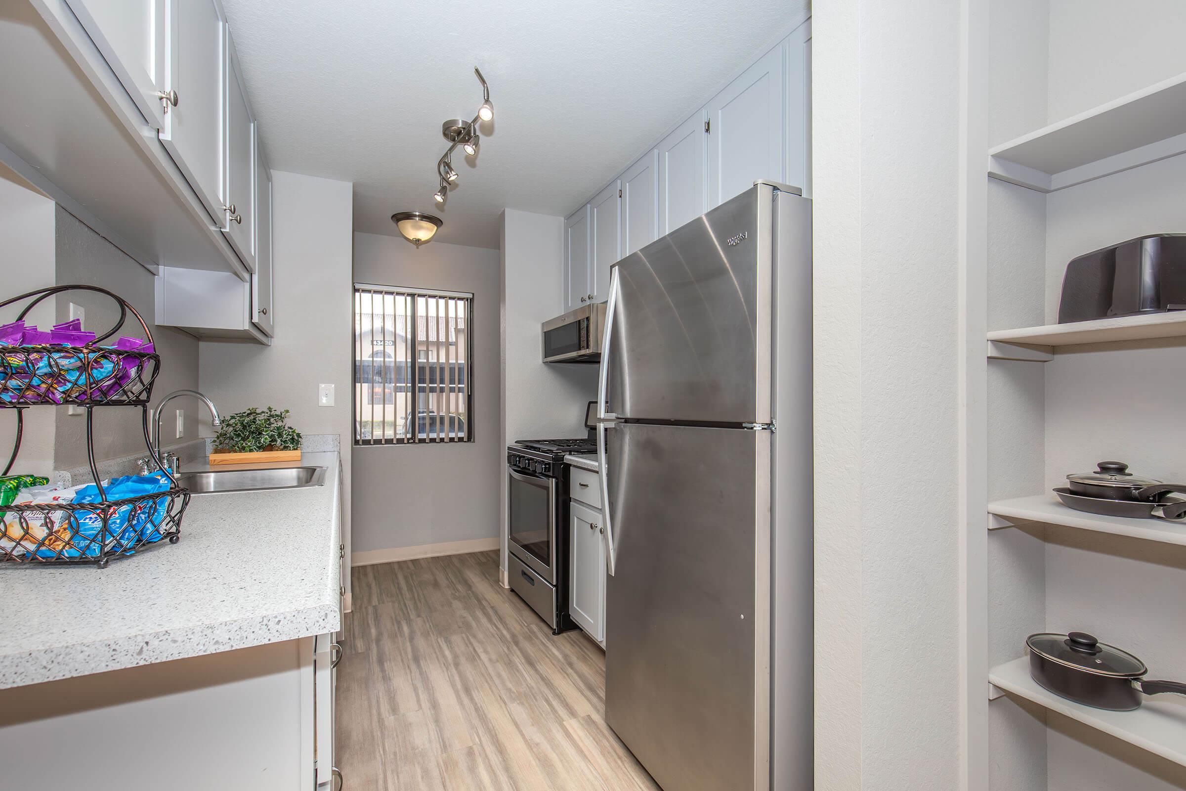 a kitchen with a sink and a mirror