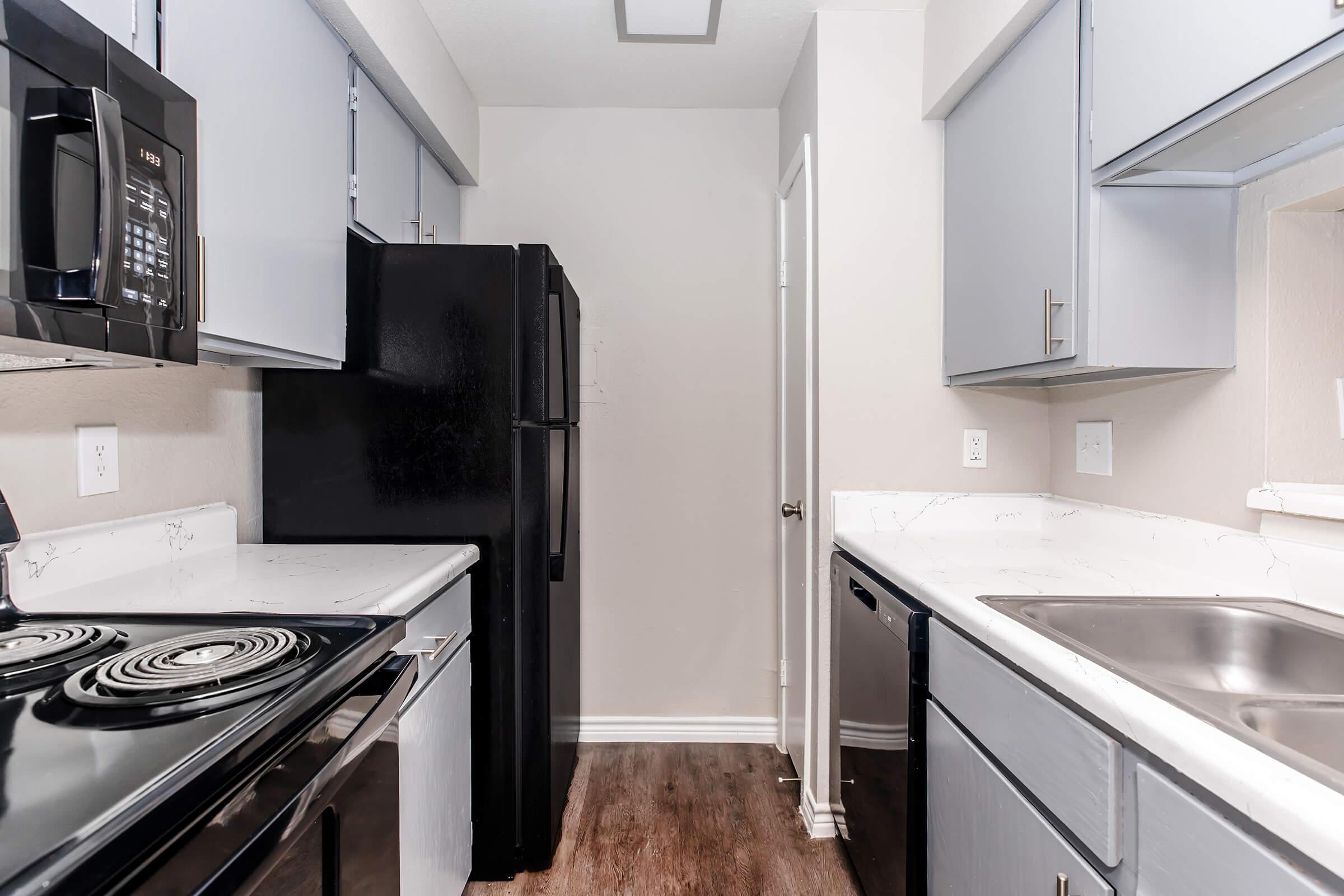 a stove top oven sitting inside of a kitchen