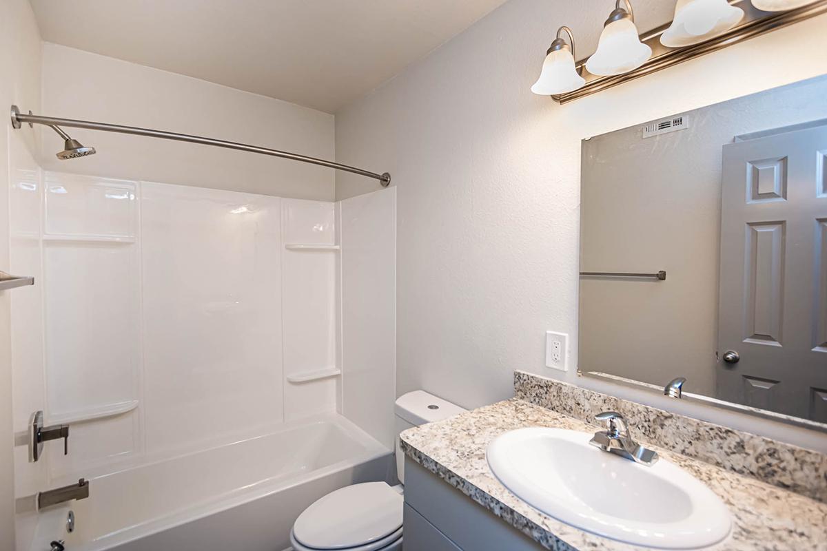 a room with a sink and a mirror