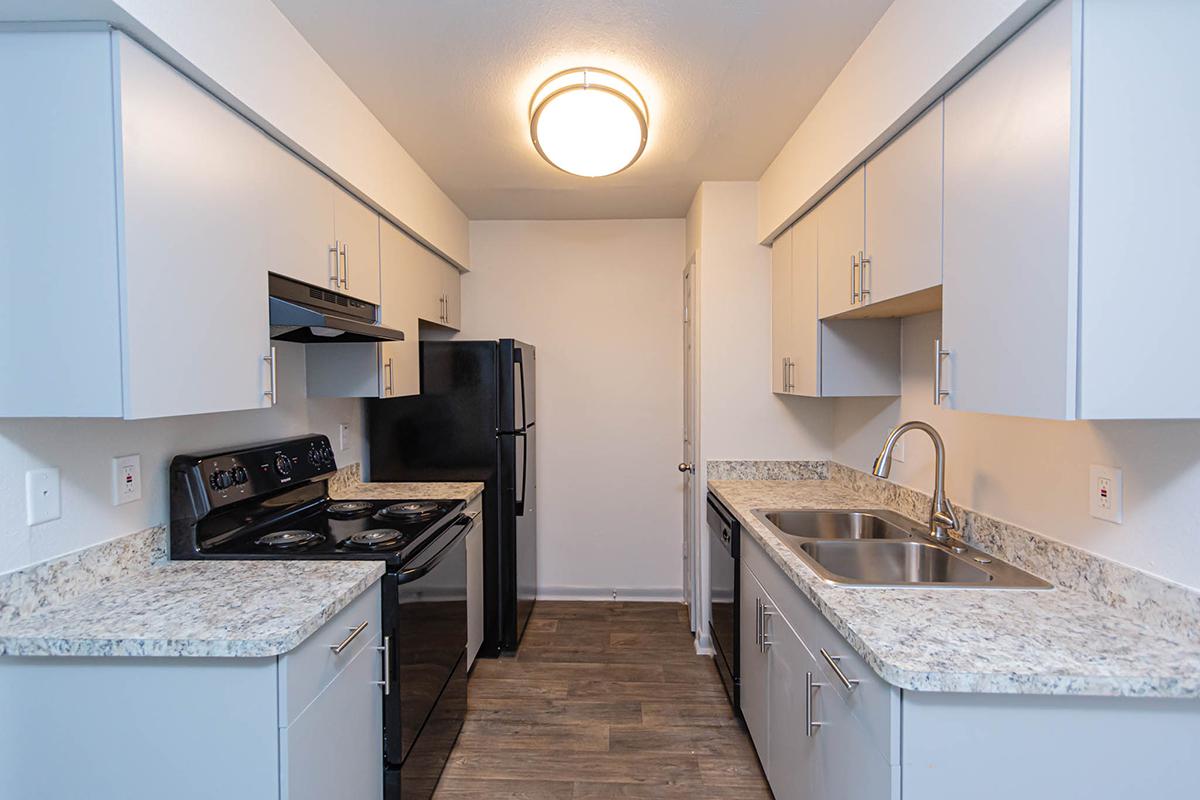 a kitchen with a stove sink and refrigerator