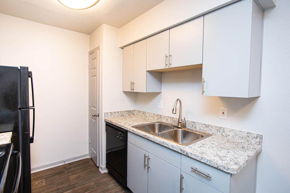 a kitchen with a sink and a mirror