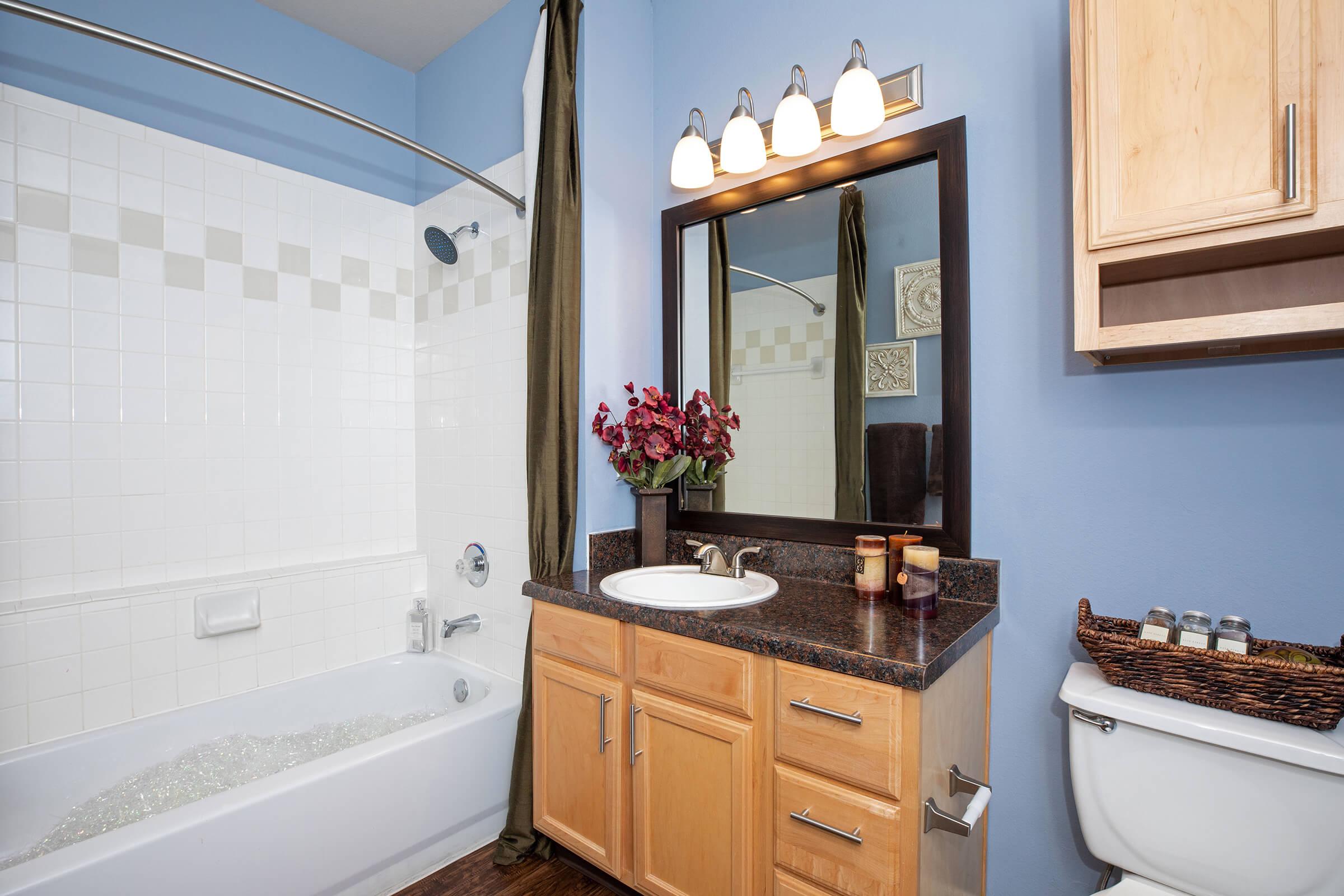 a kitchen with a sink and a mirror