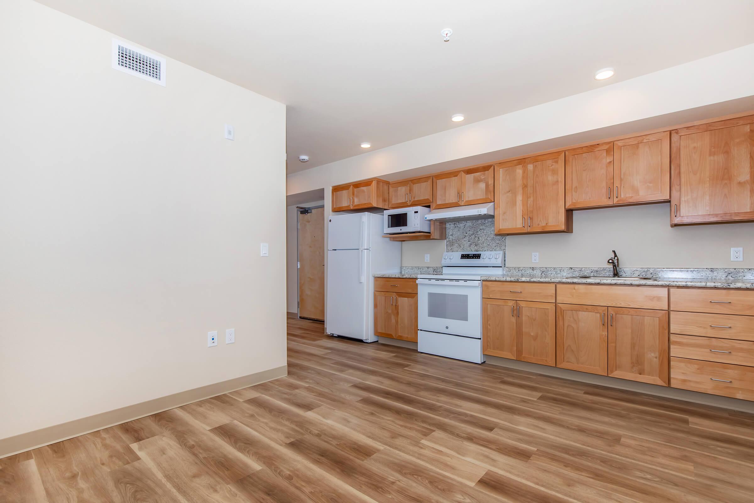 a kitchen with a wood floor