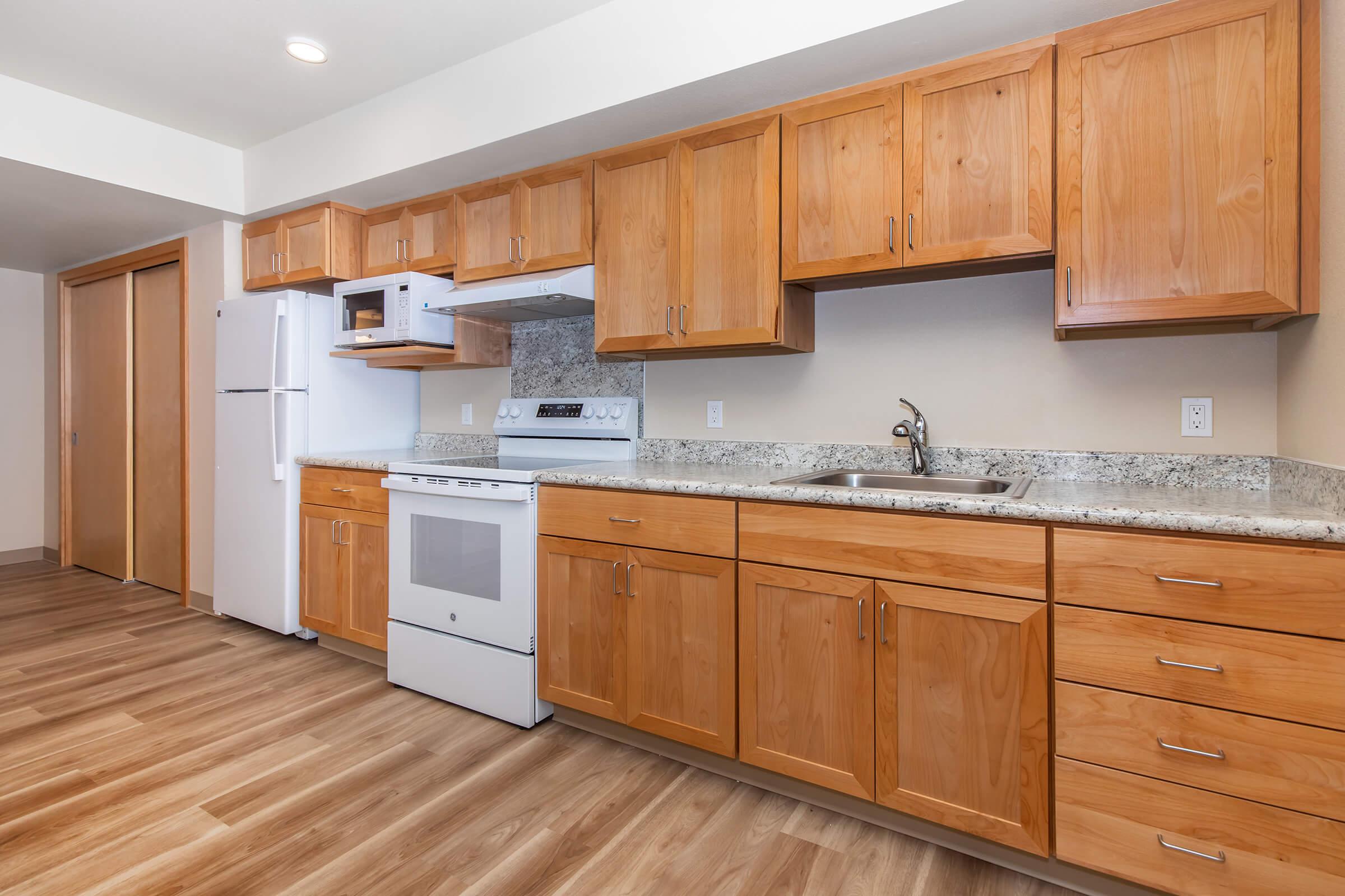 a kitchen with stainless steel appliances and wooden cabinets