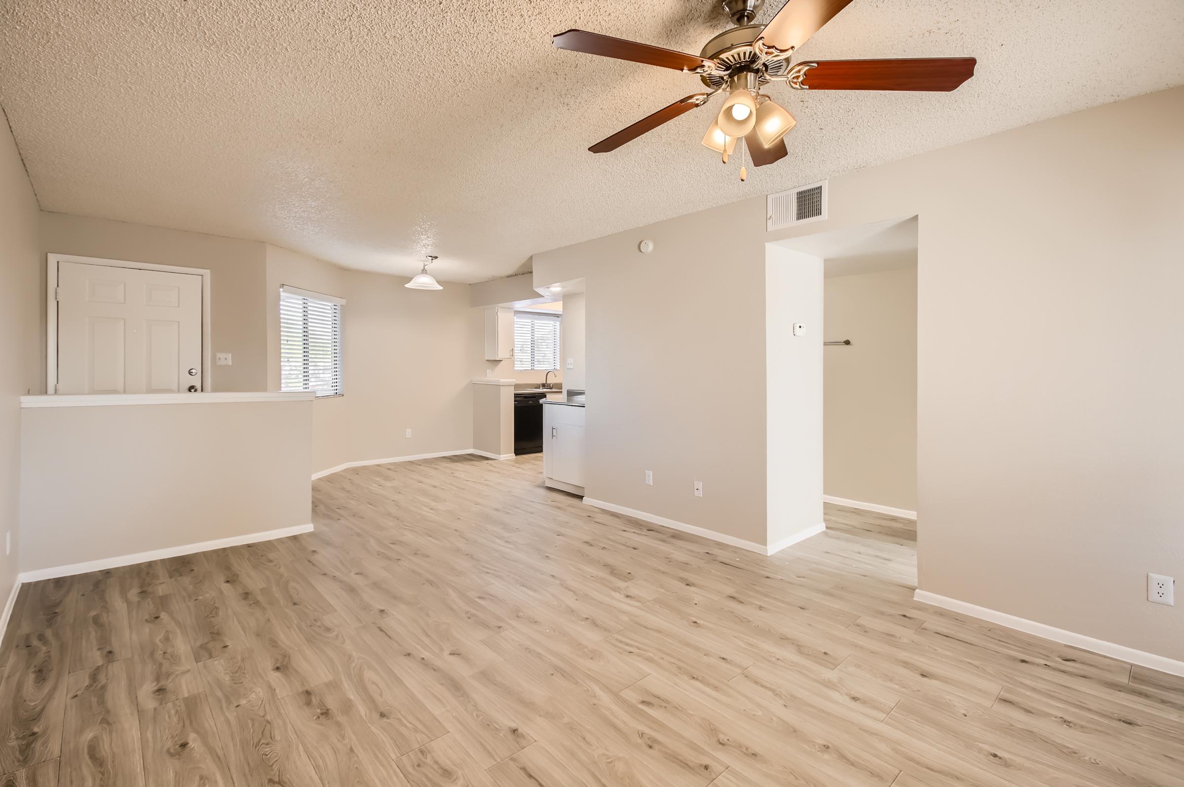 Rise Desert Cove Phoenix, AZ apartment with an open floor plan with a ceiling fan and view of the kitchen
