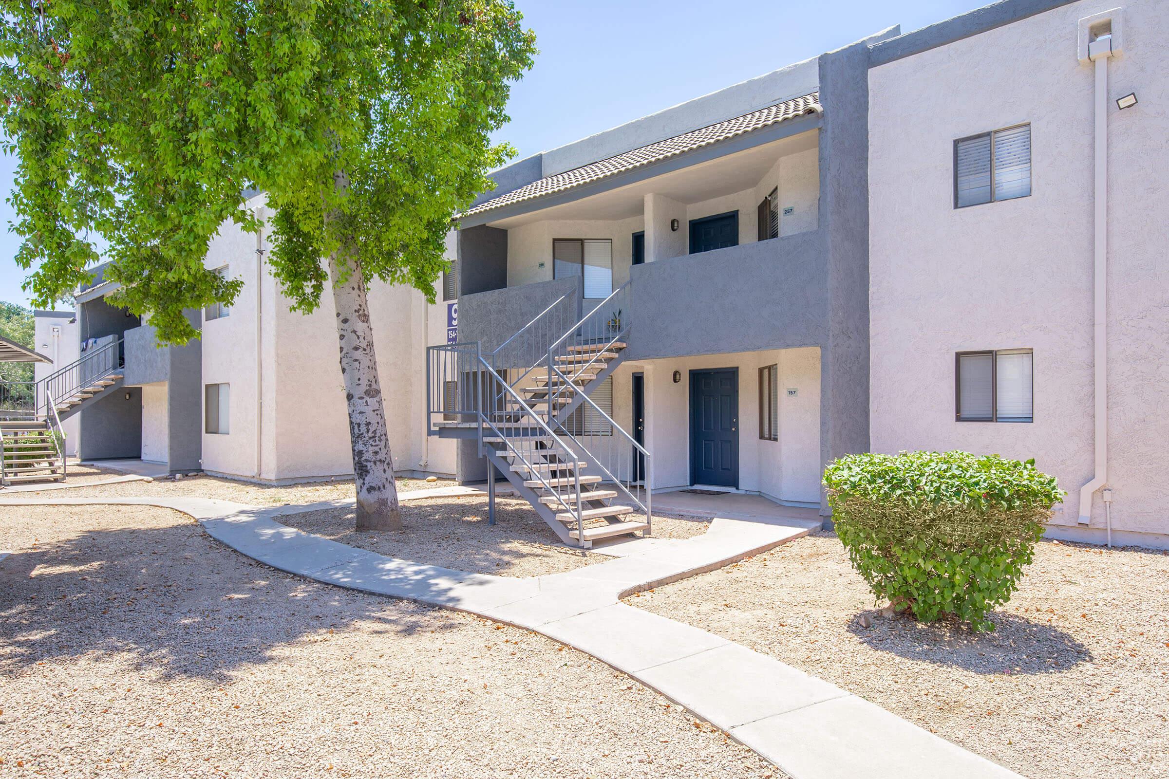 Outdoor view of Rise Desert Cove's apartments for rent in Phoenix, AZ with a walkway and  gravel landscaping