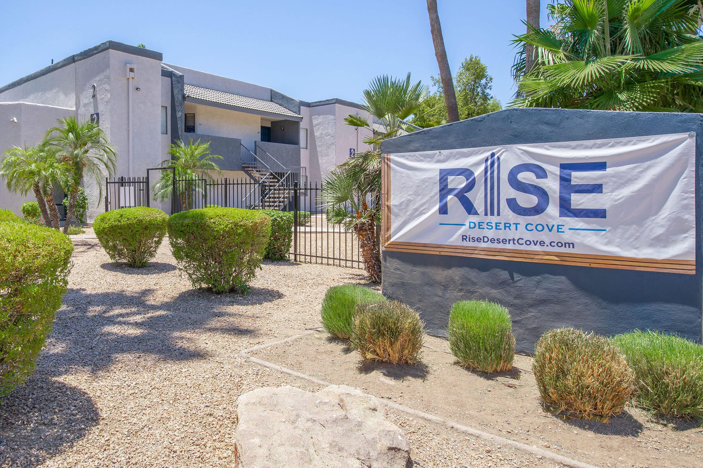Rise Desert Cove outdoor signage and landscaping in front of their Phoenix, AZ apartment bui.doing