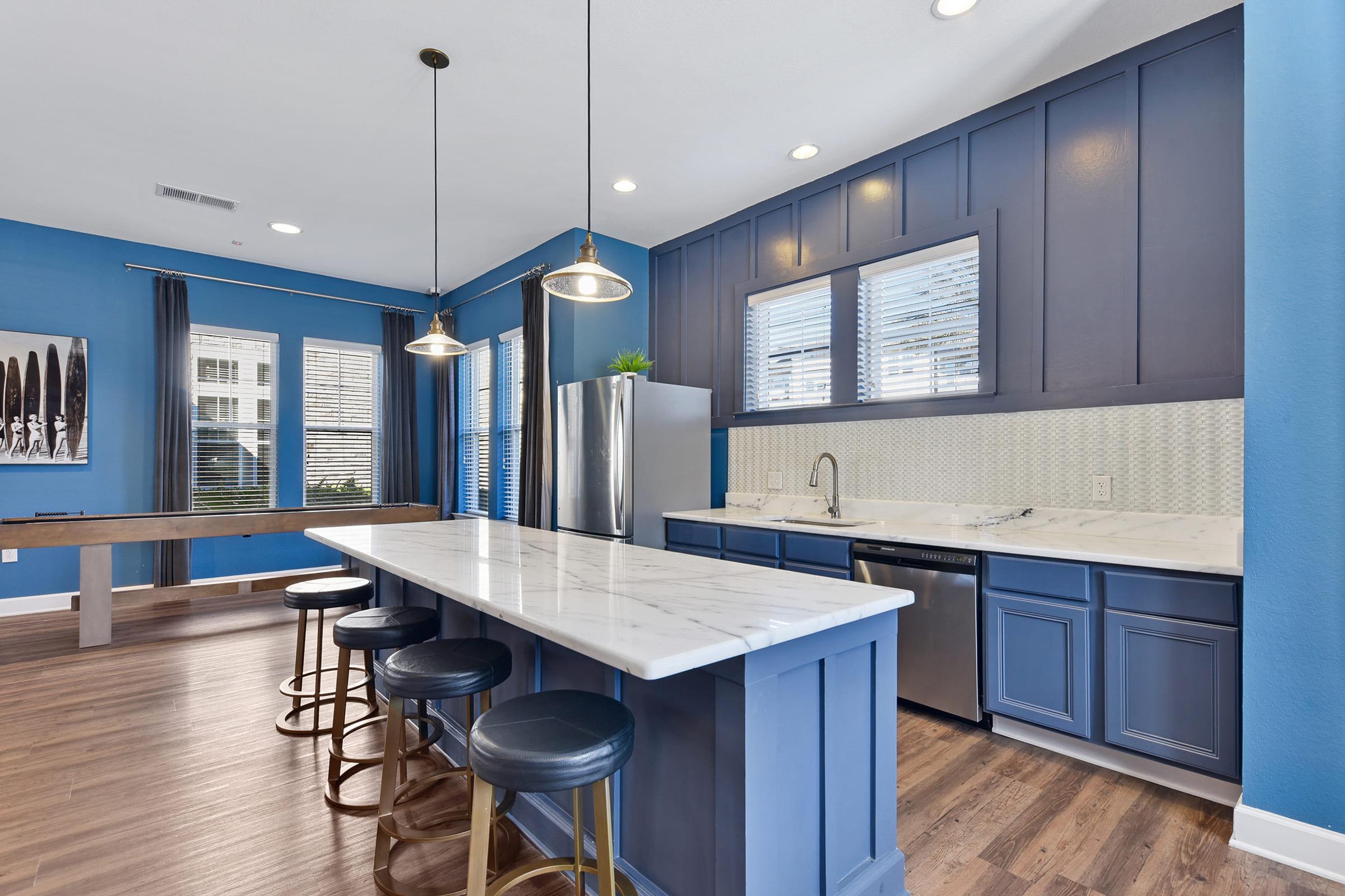 a modern kitchen with stainless steel appliances and wooden cabinets