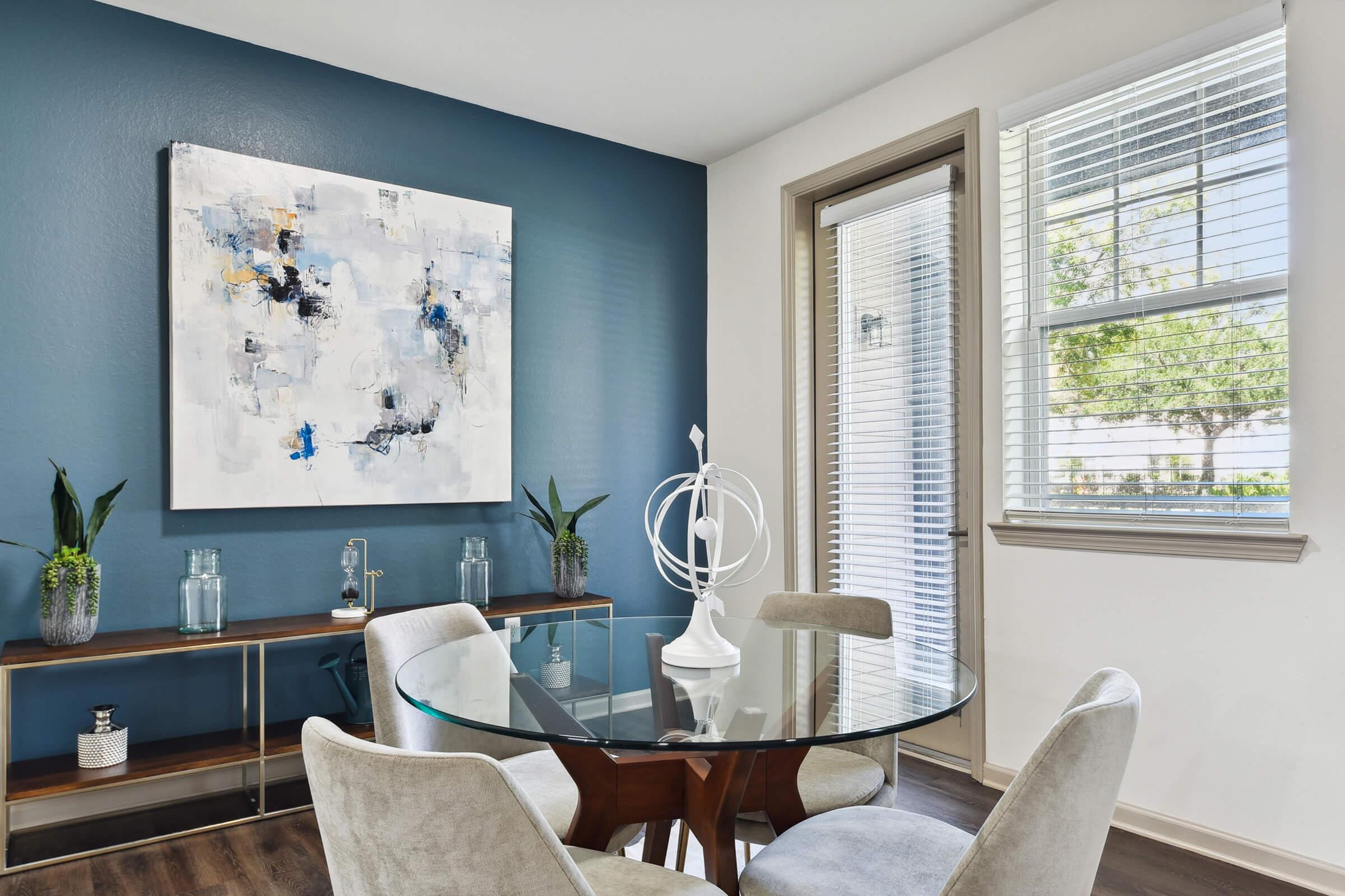 a living room filled with furniture and a large window