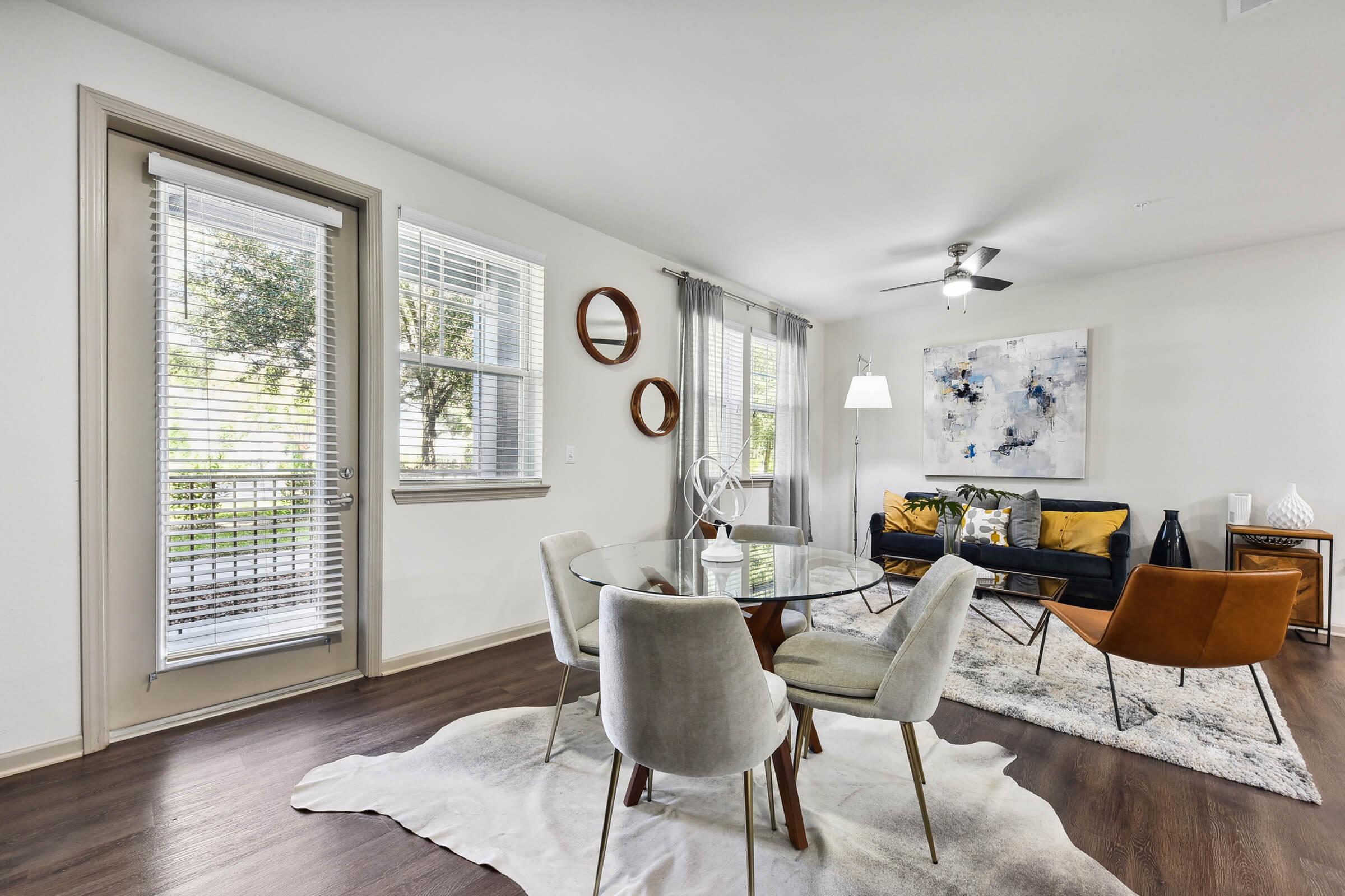 a living room filled with furniture and a large window