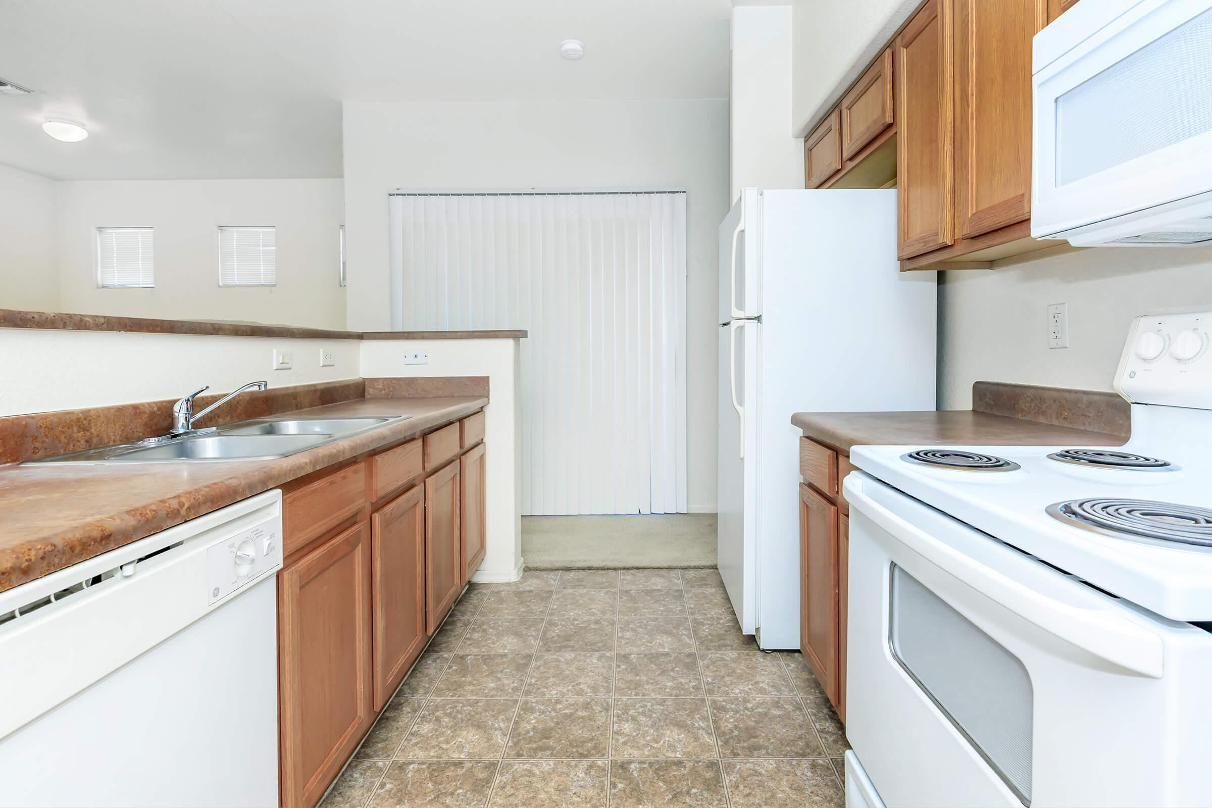 a kitchen with a stove sink and refrigerator