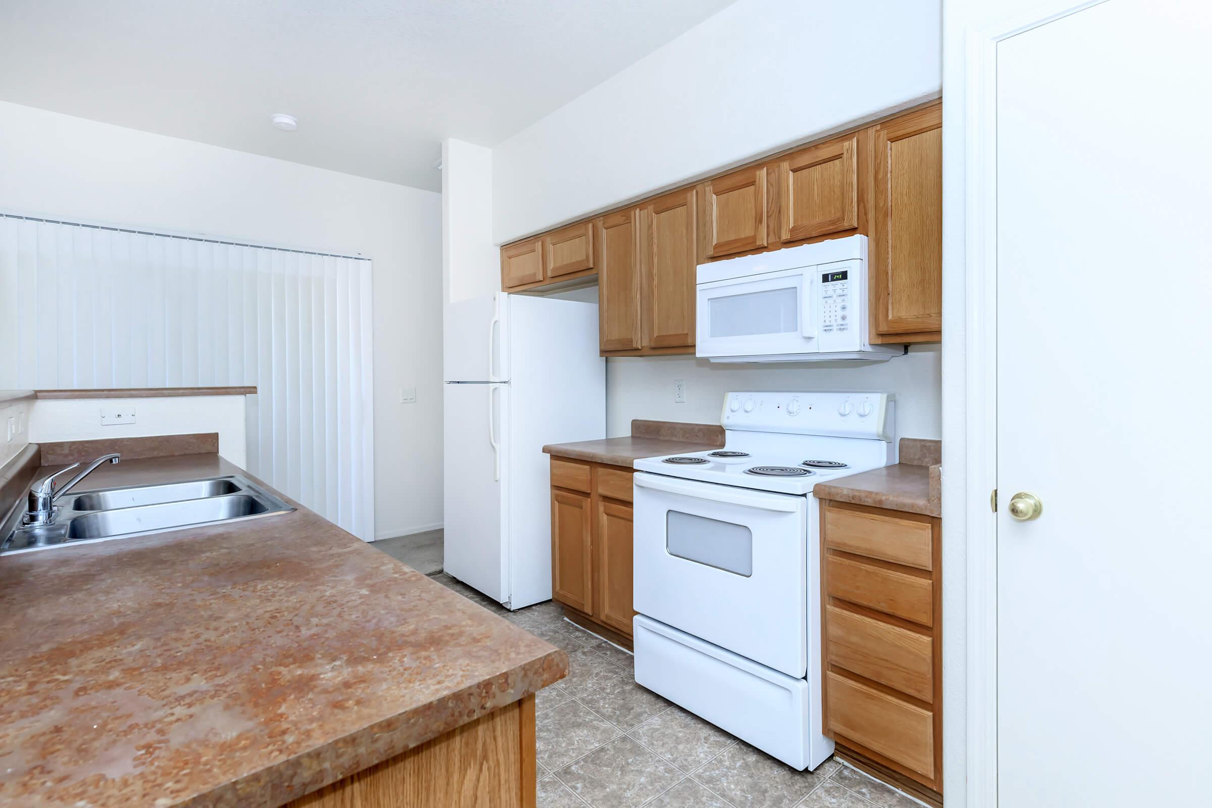 a kitchen with wooden cabinets