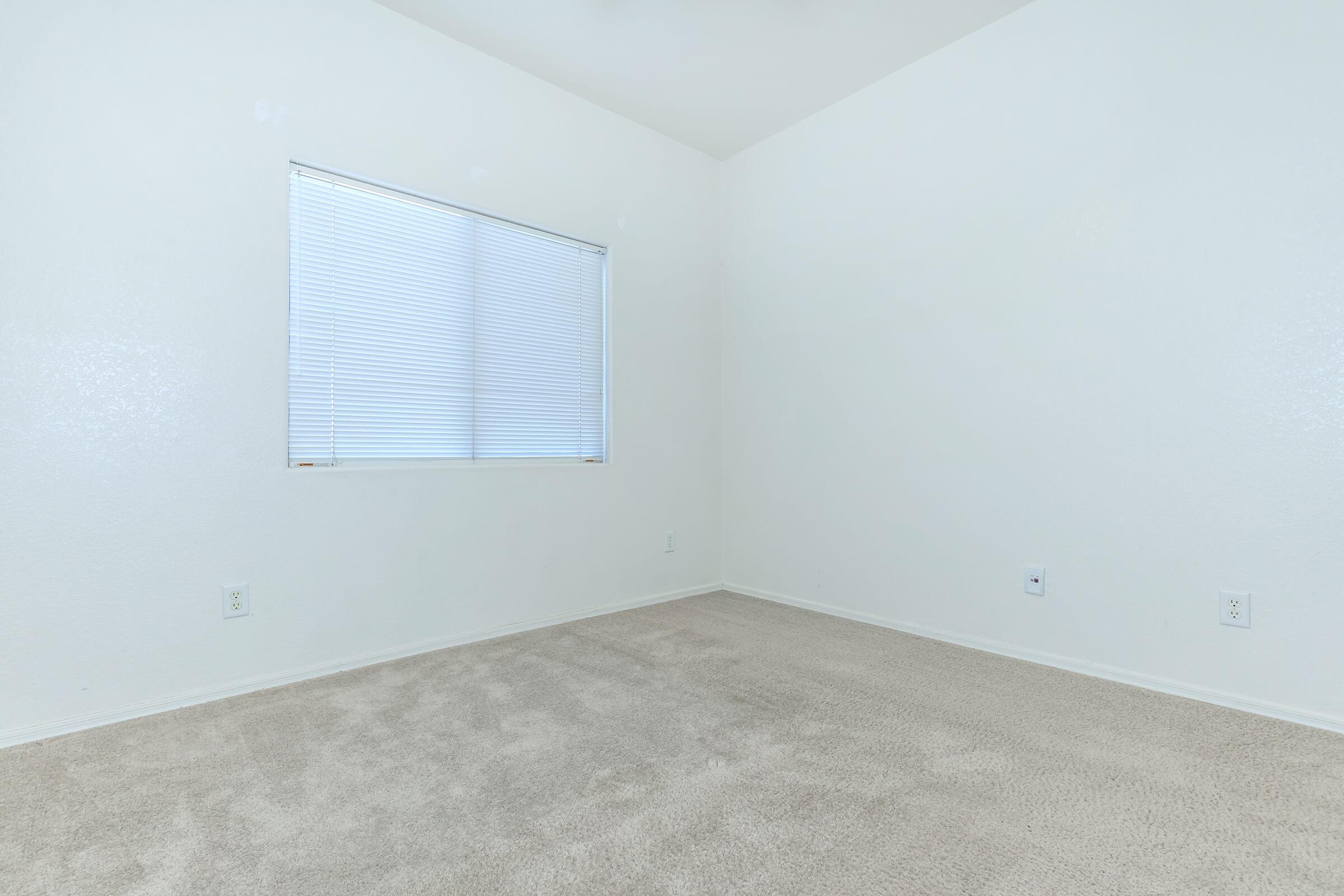 a bedroom with a large window