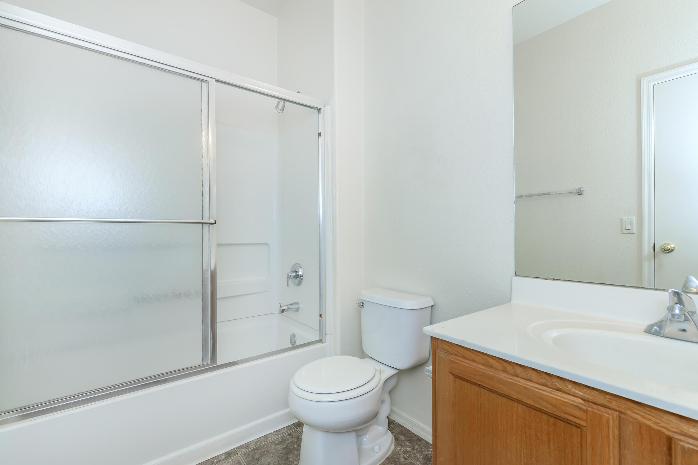 a white tub sitting next to a shower